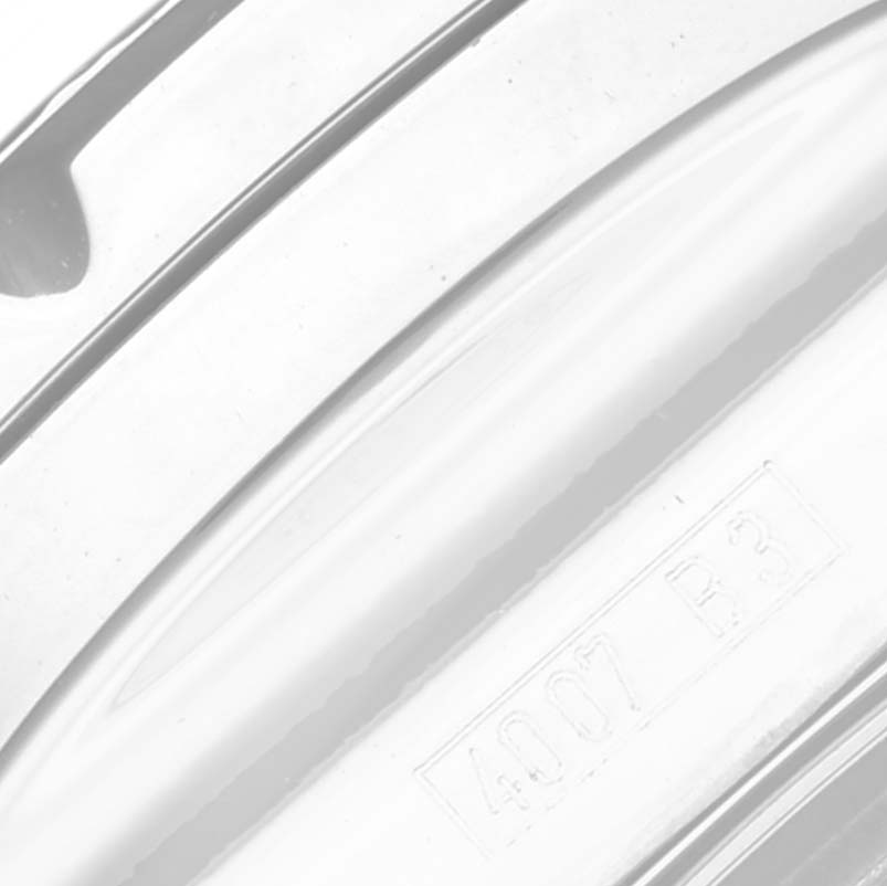 The image shows a close-up of the metal bracelet or component of the Bentley model by Breitling with engraved details.