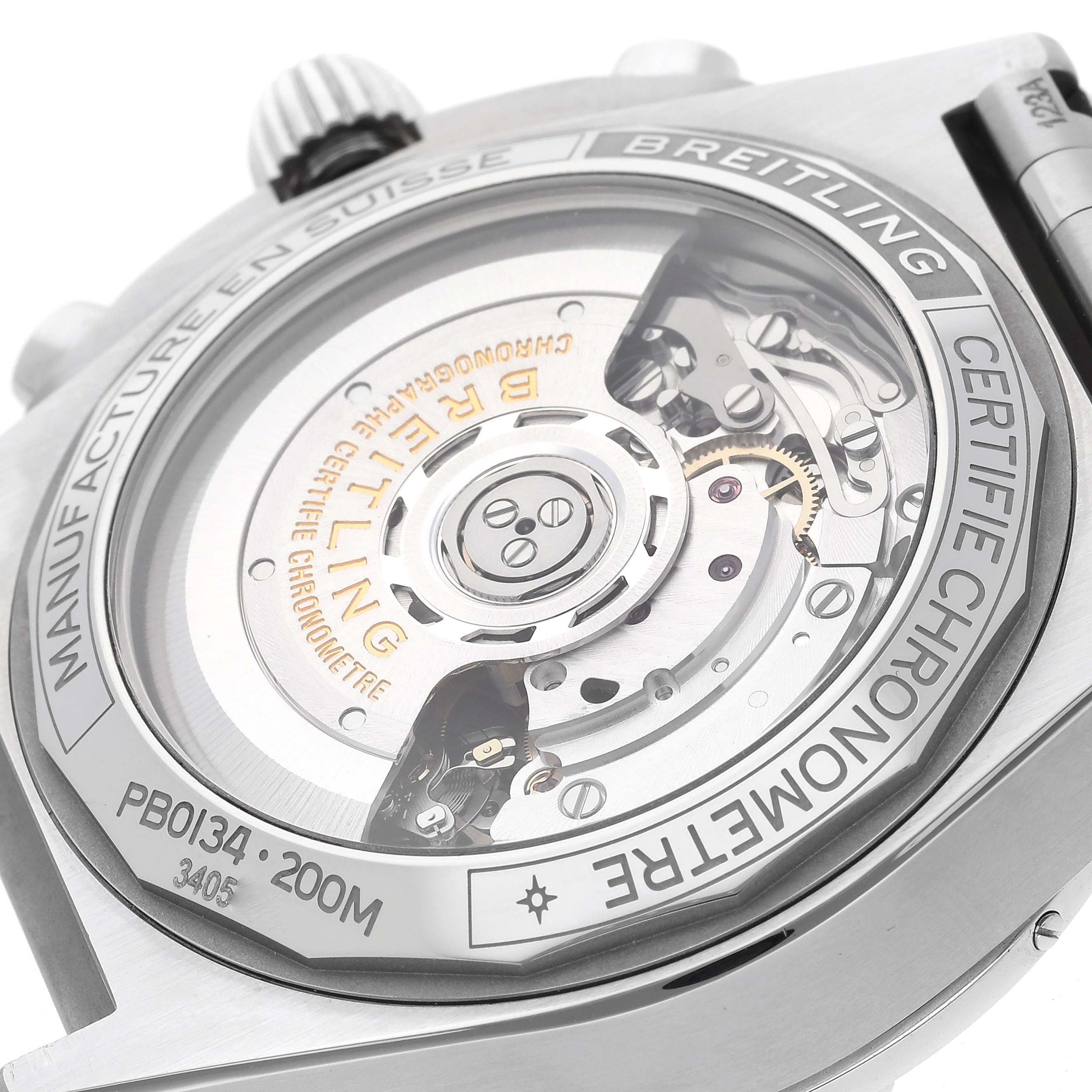 The image shows the case back of a Breitling Chronomat PB0134101C1S1 Men's Stainless Steel Blue Dial PB0134101C1S1 Men's Stainless Steel Blue Dial watch, highlighting the inner mechanical movement and engravings.