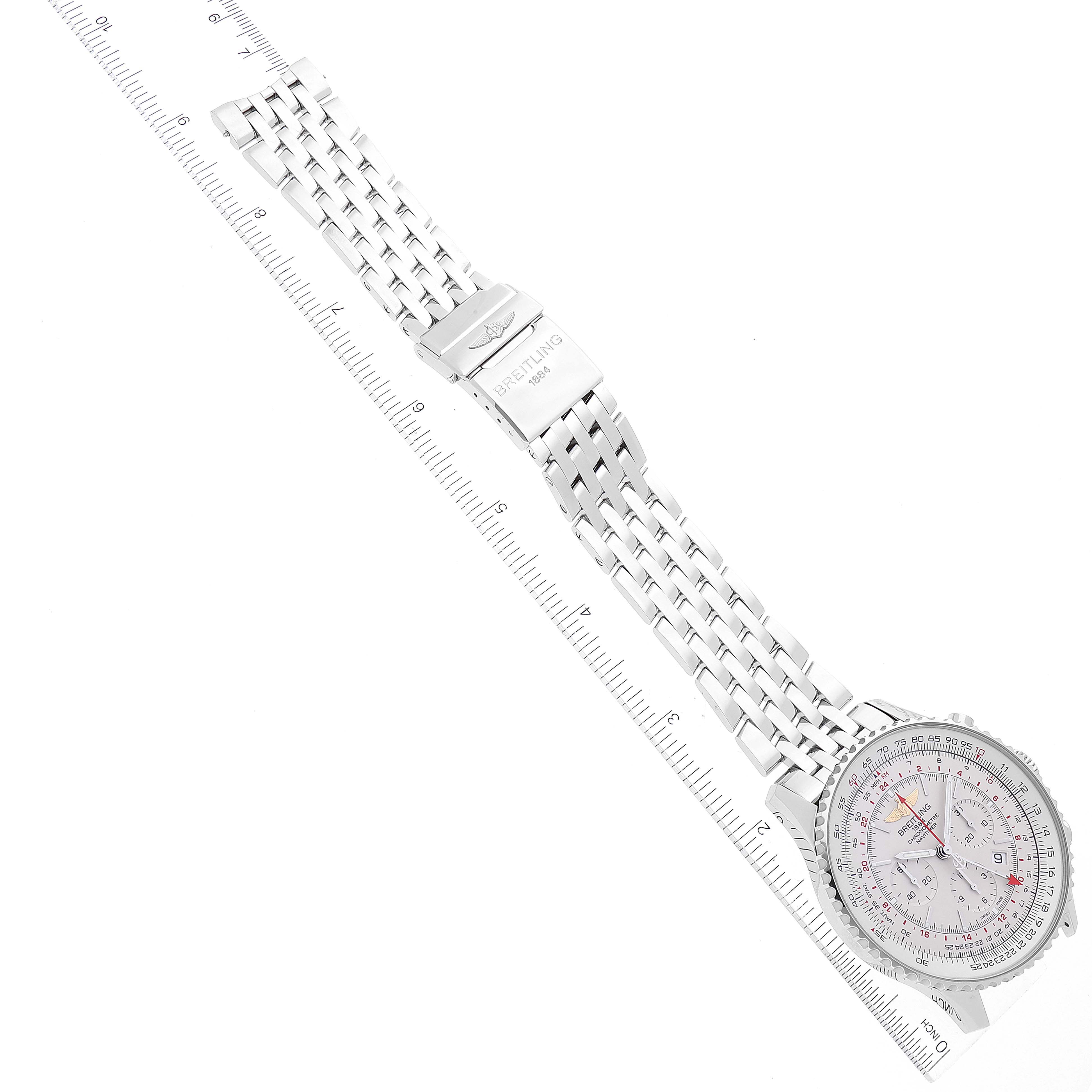 This image shows a top-down angle of a Breitling Navitimer AB0441 Men's Stainless Steel Silver Dial AB0441 Men's Stainless Steel Silver Dial watch with a silver mesh band next to a ruler.