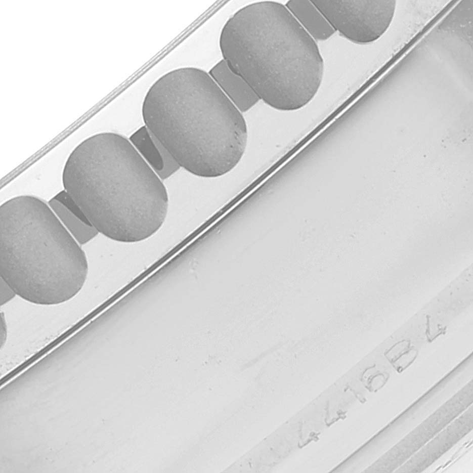 This is a close-up view of the bezel details and part of the case with a serial number of the Breitling Navitimer AB0441 Men's Stainless Steel Silver Dial AB0441 Men's Stainless Steel Silver Dial watch.