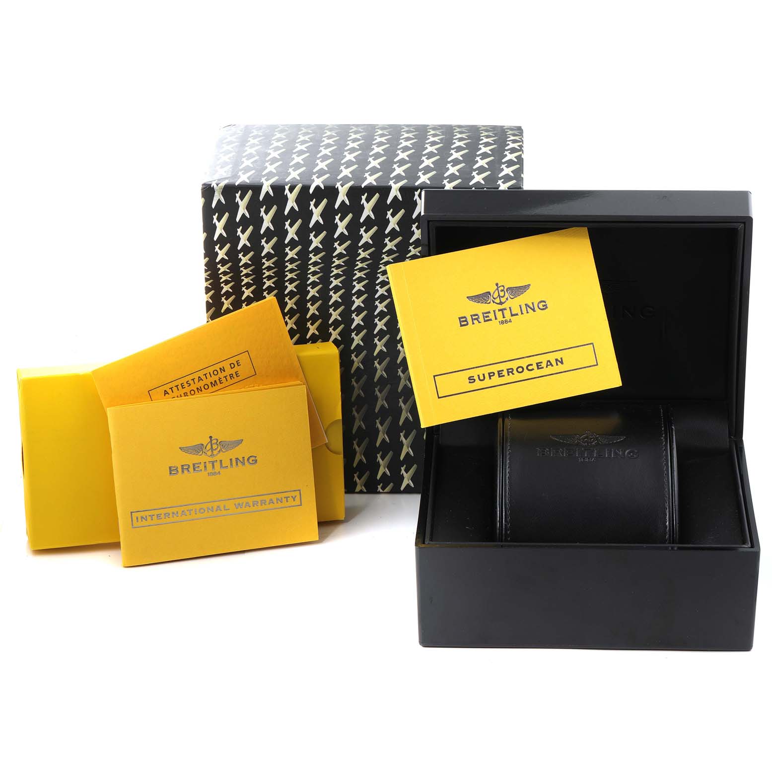 The image shows the packaging, international warranty card, and instruction manual for a Breitling Superocean A17364 Men's Stainless Steel Black Dial A17364 Men's Stainless Steel Black Dial watch.