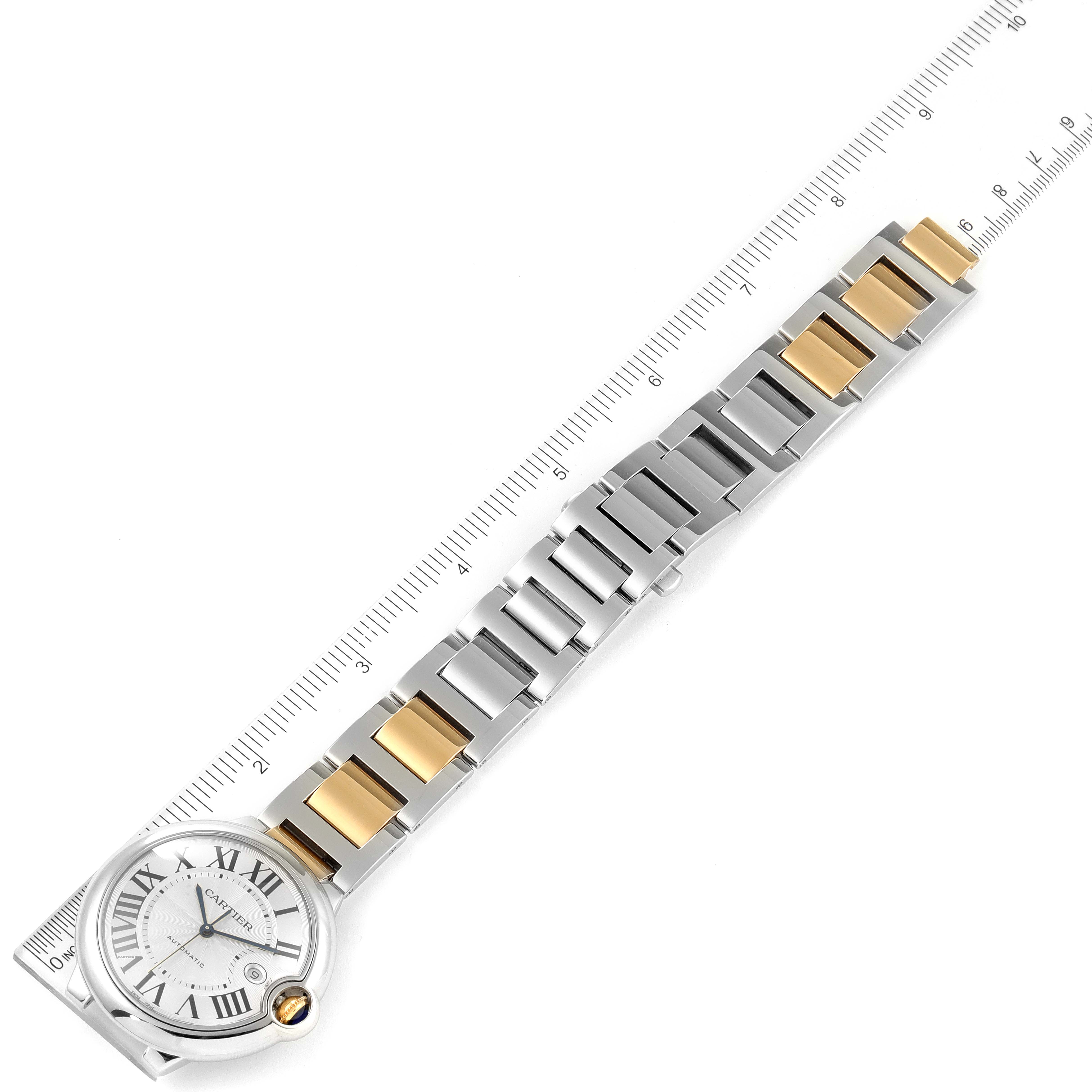 The image shows the full strap and face of the Cartier Ballon Bleu W6900923 Men's Steel and Gold (two tone) Silver Dial W6900923 Men's Steel and Gold (two tone) Silver Dial watch laid flat next to a measuring ruler.