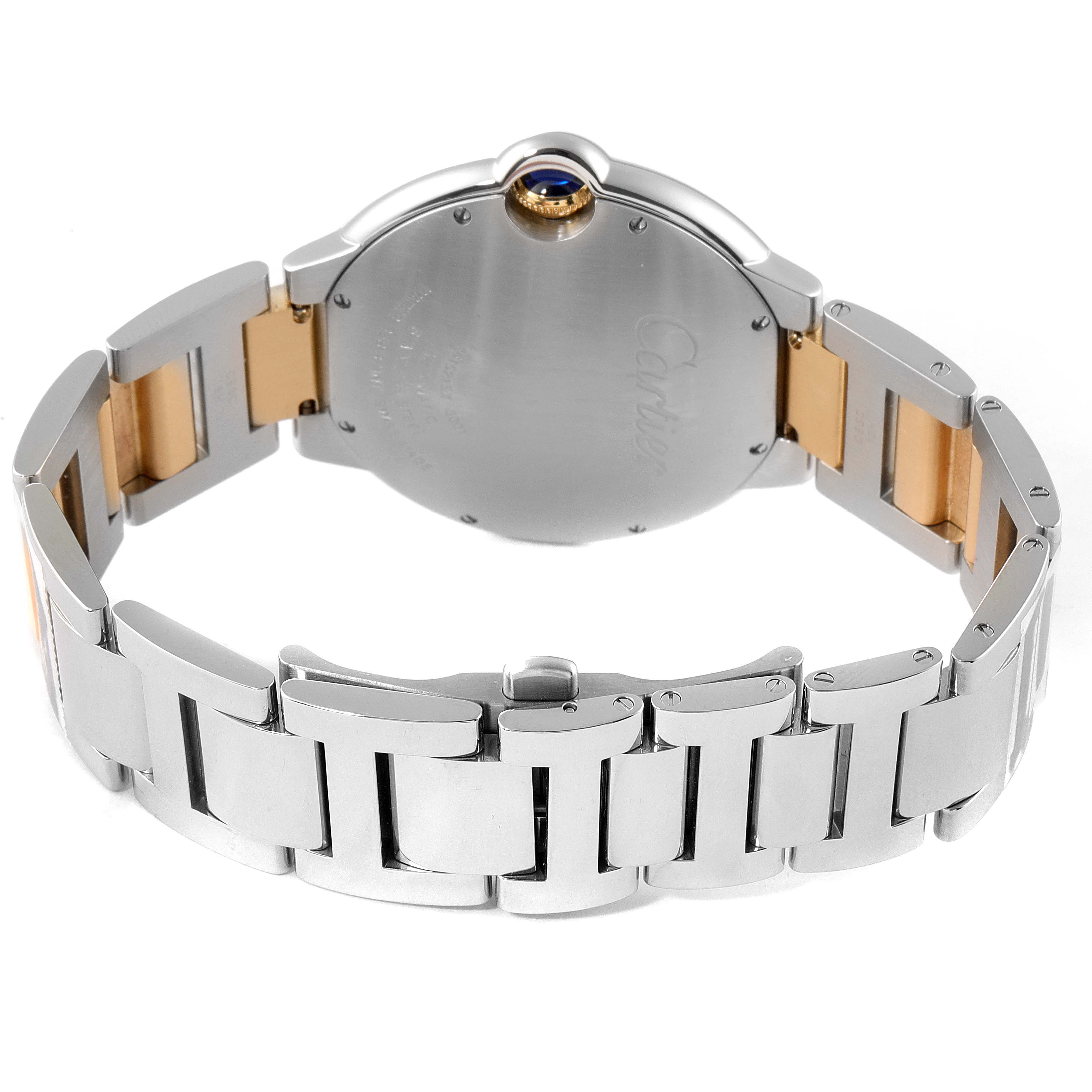 The image shows the back view of a Ballon Bleu de Cartier watch, focusing on the case back and metallic bracelet.