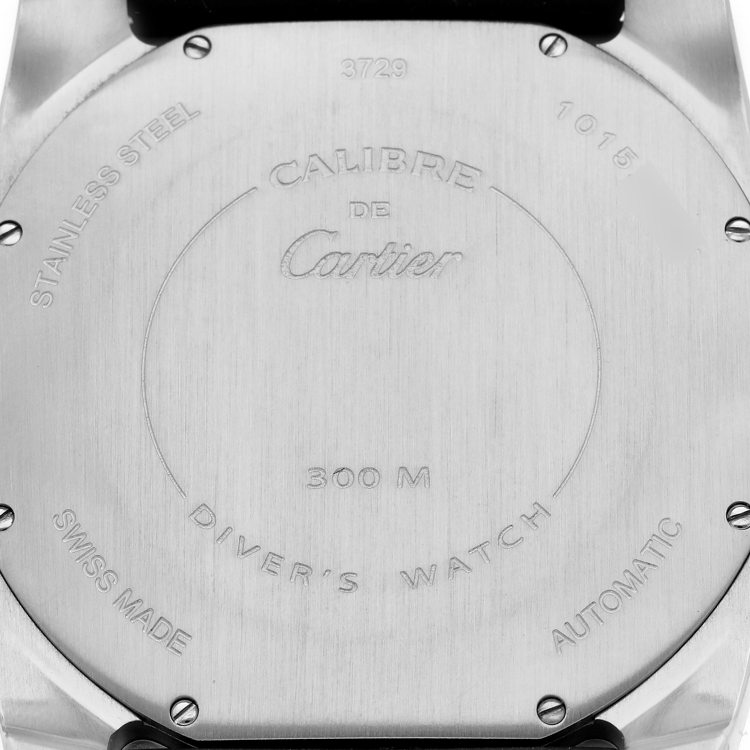 The image shows the stainless steel case back of a Calibre de Cartier watch, featuring brand engravings and specifications.