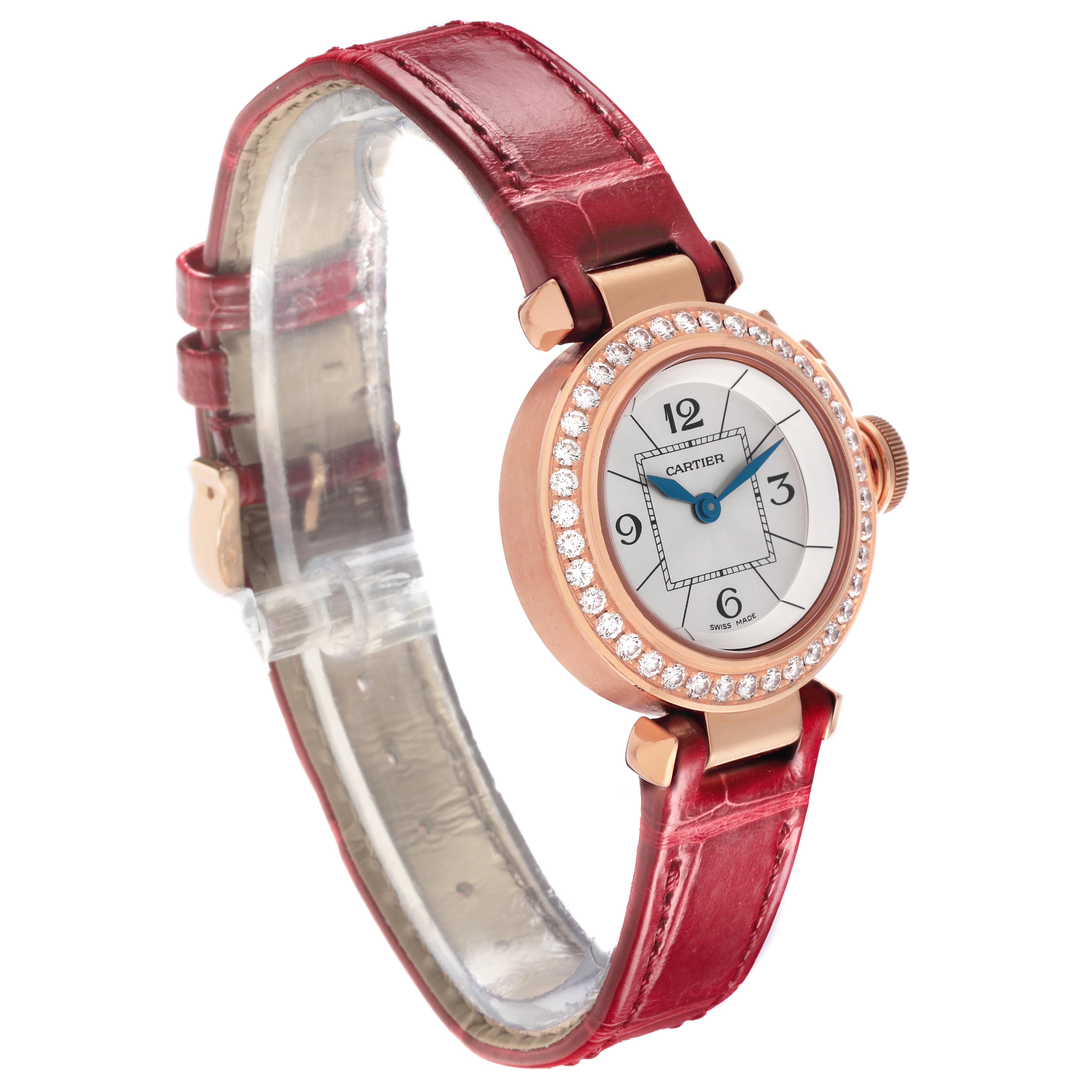 The Cartier Pasha WJ124026 Women's Rose Gold Silver Dial WJ124026 Women's Rose Gold Silver Dial watch is shown at an angle displaying the watch face, bezel with diamonds, crown, and red leather strap.