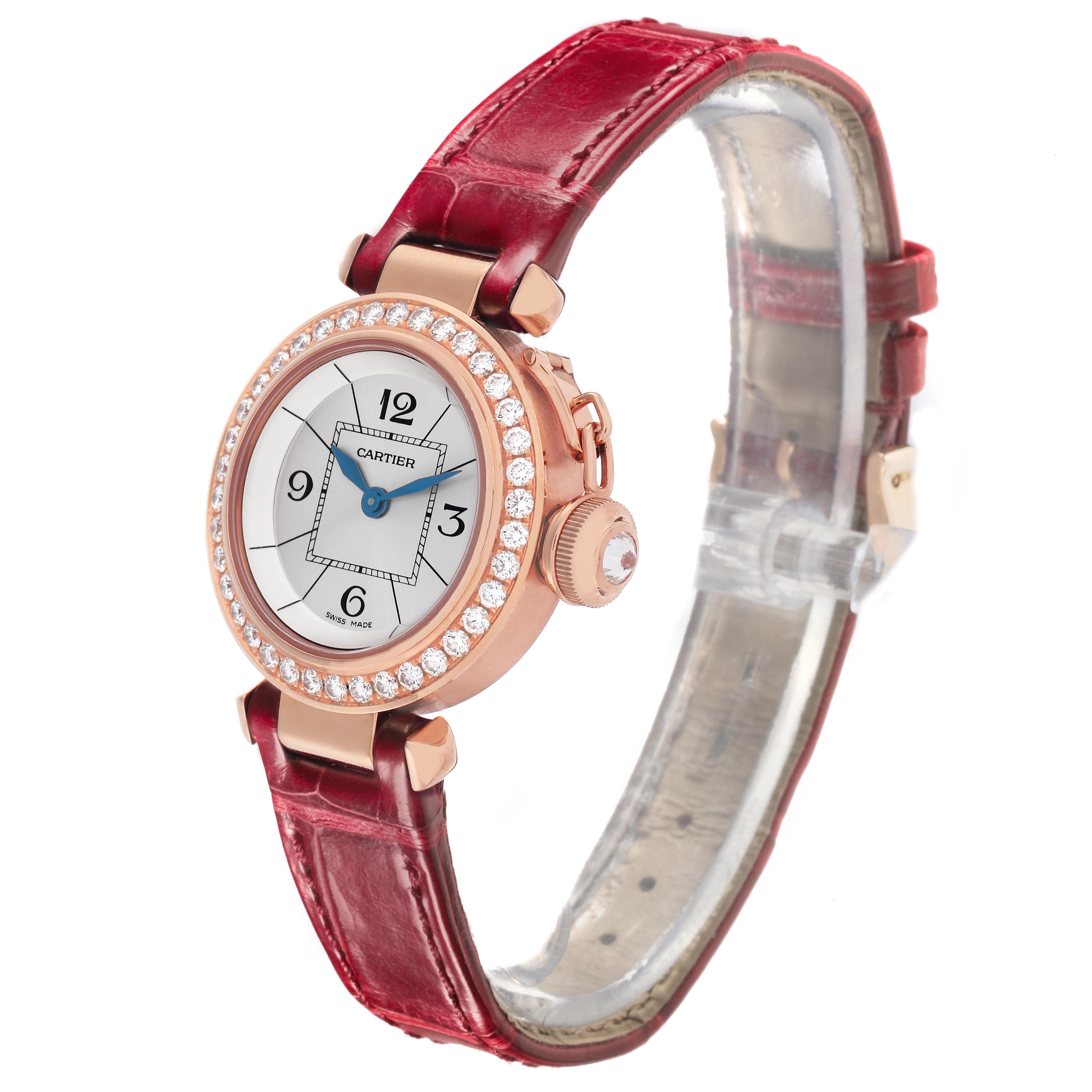The Cartier Pasha WJ124026 Women's Rose Gold Silver Dial WJ124026 Women's Rose Gold Silver Dial watch is shown at a slight angle, displaying the dial, diamond bezel, crown, and red leather strap.