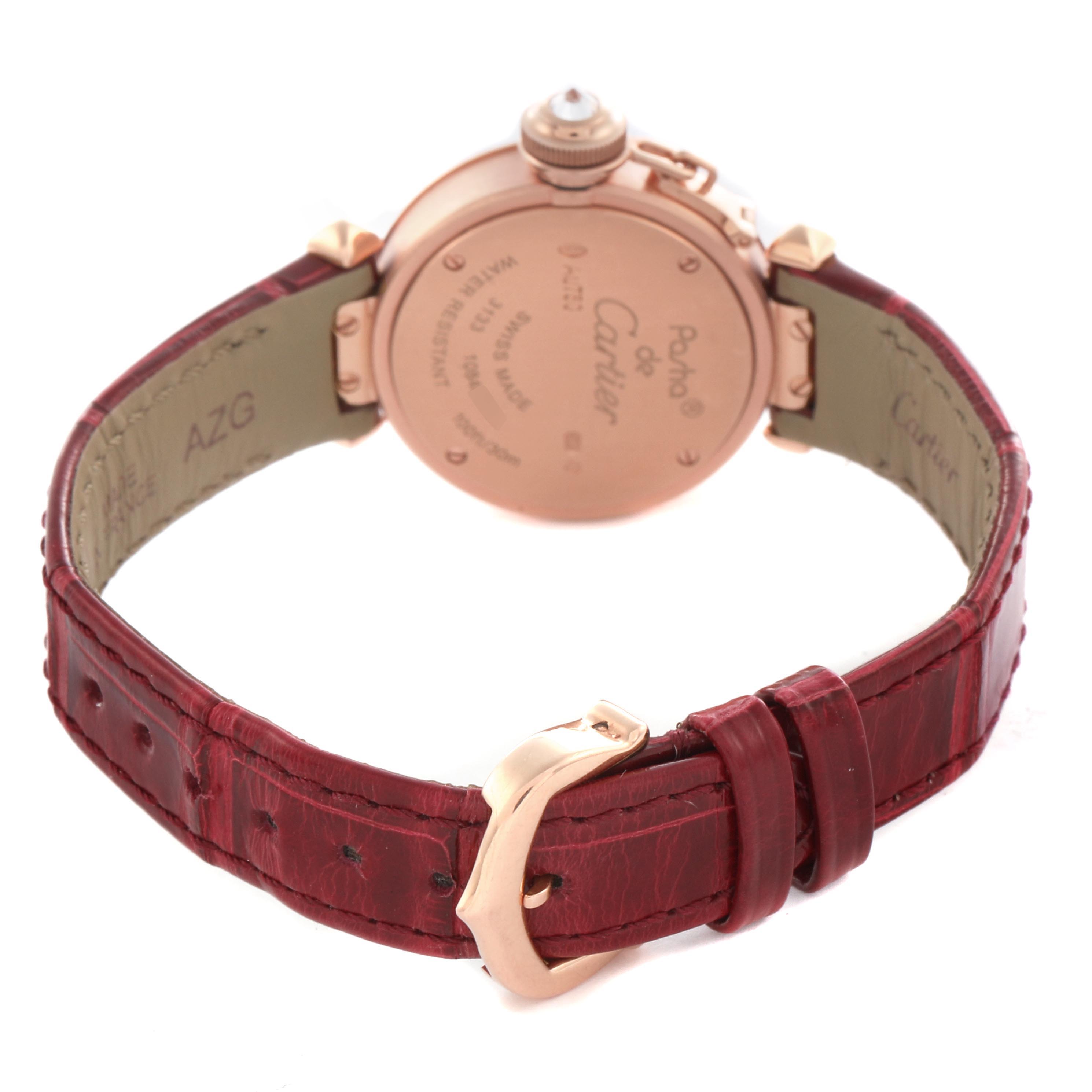 The Cartier Pasha WJ124026 Women's Rose Gold Silver Dial WJ124026 Women's Rose Gold Silver Dial watch is shown from the back, featuring the case back, crown, and red leather strap with a visible buckle.