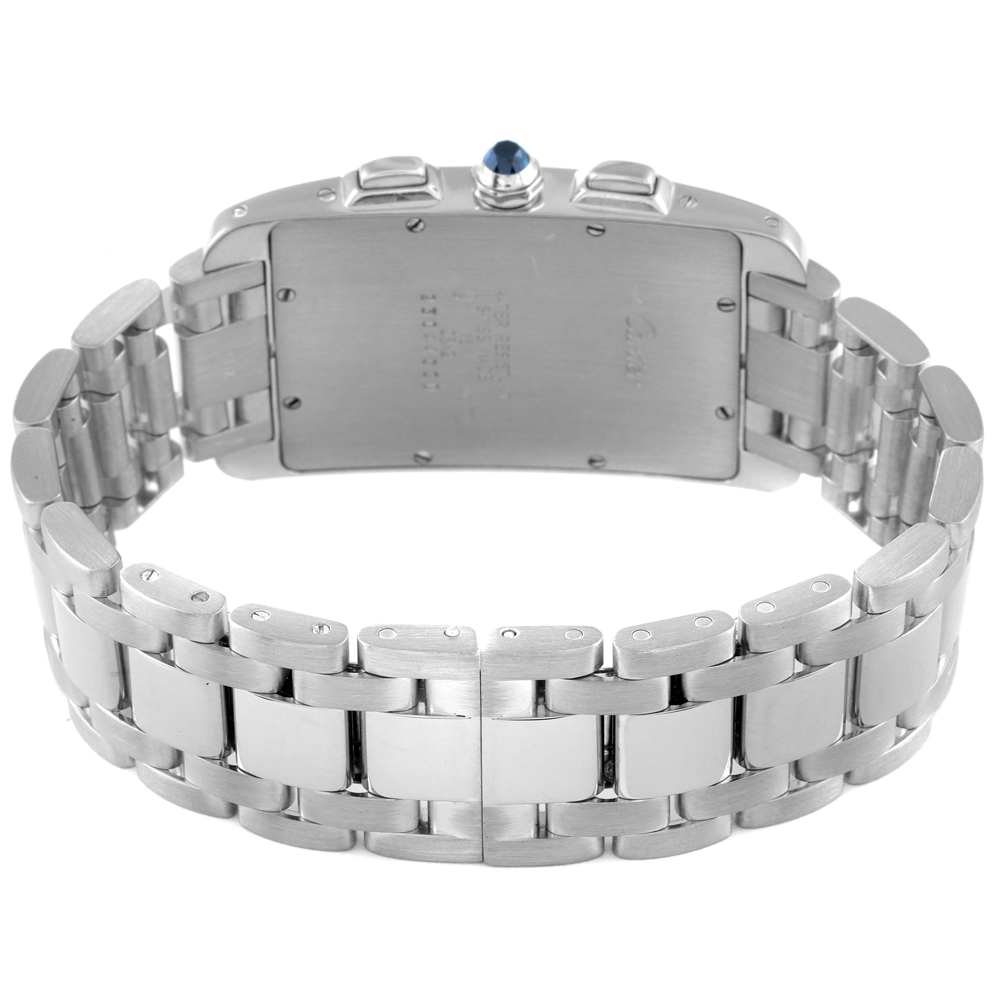 The image shows the back of a Cartier Tank Américaine watch, highlighting the stainless steel case and bracelet.