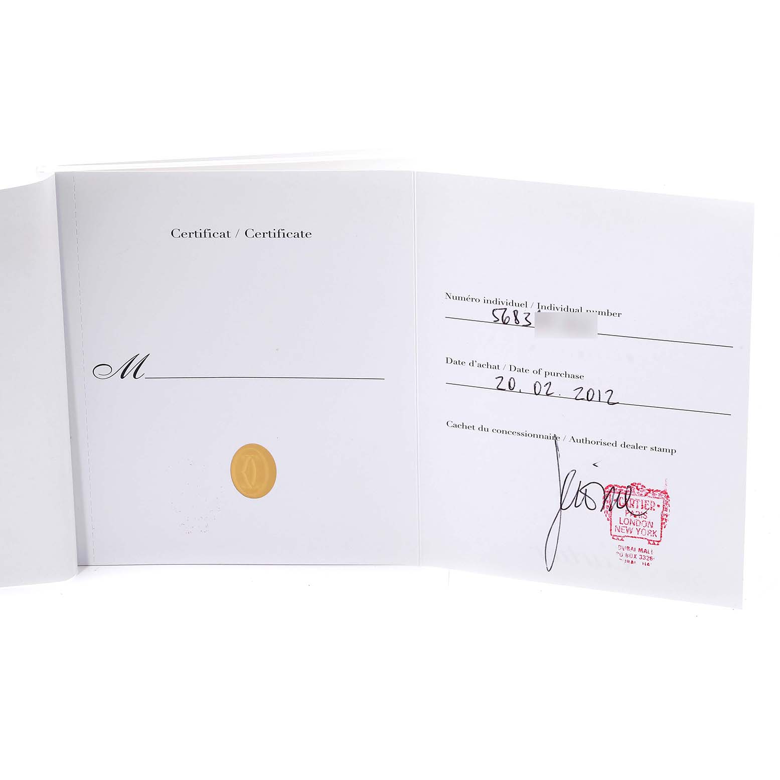 The image shows an open Tank Francaise by Cartier certificate and warranty card.