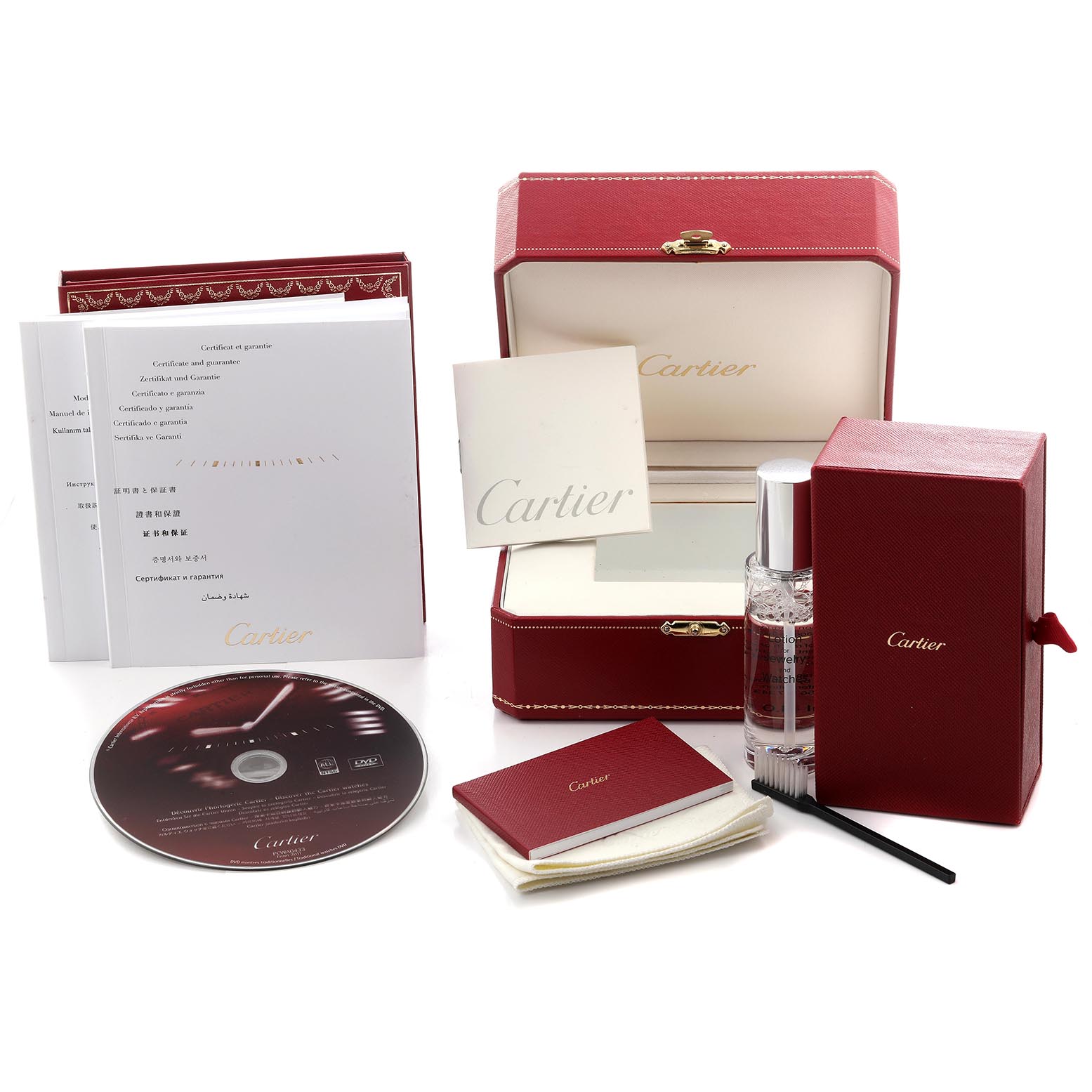 The image shows a Cartier Tank Francaise W51011Q3 Women's Stainless Steel Silver Dial W51011Q3 Women's Stainless Steel Silver Dial watch box set including manuals, a DVD, a cleaning kit, and a polishing cloth from an angled view.