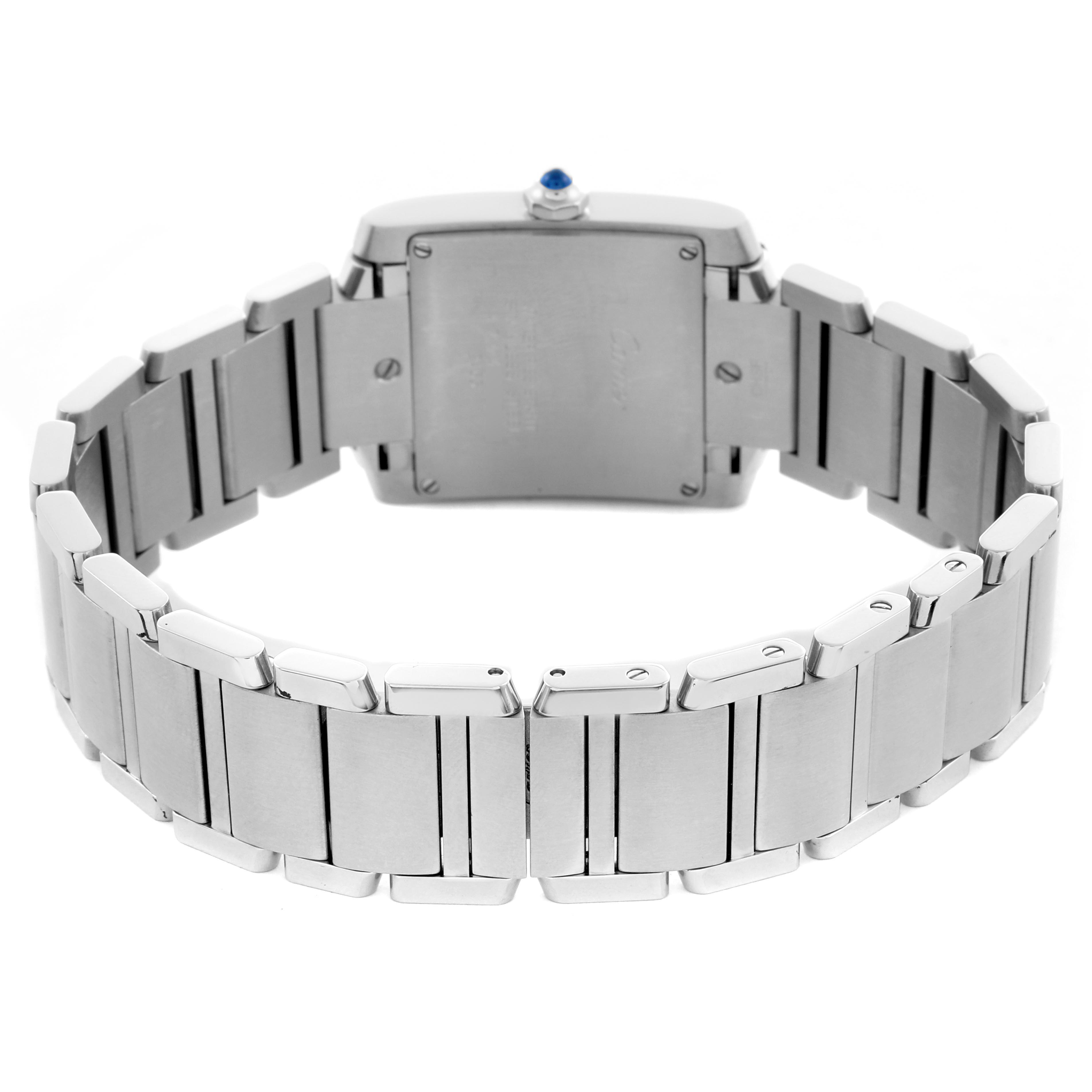 The Cartier Tank Française watch is shown from the back, highlighting its metal bracelet and case back, including the crown.