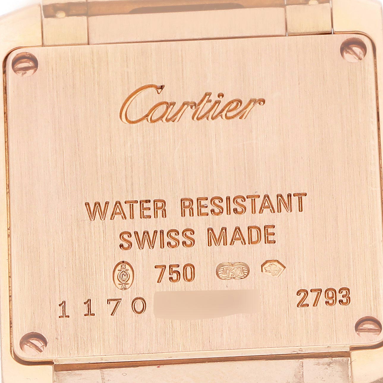 The image shows the back case of a Cartier Tank Française watch, featuring engravings and hallmarks.