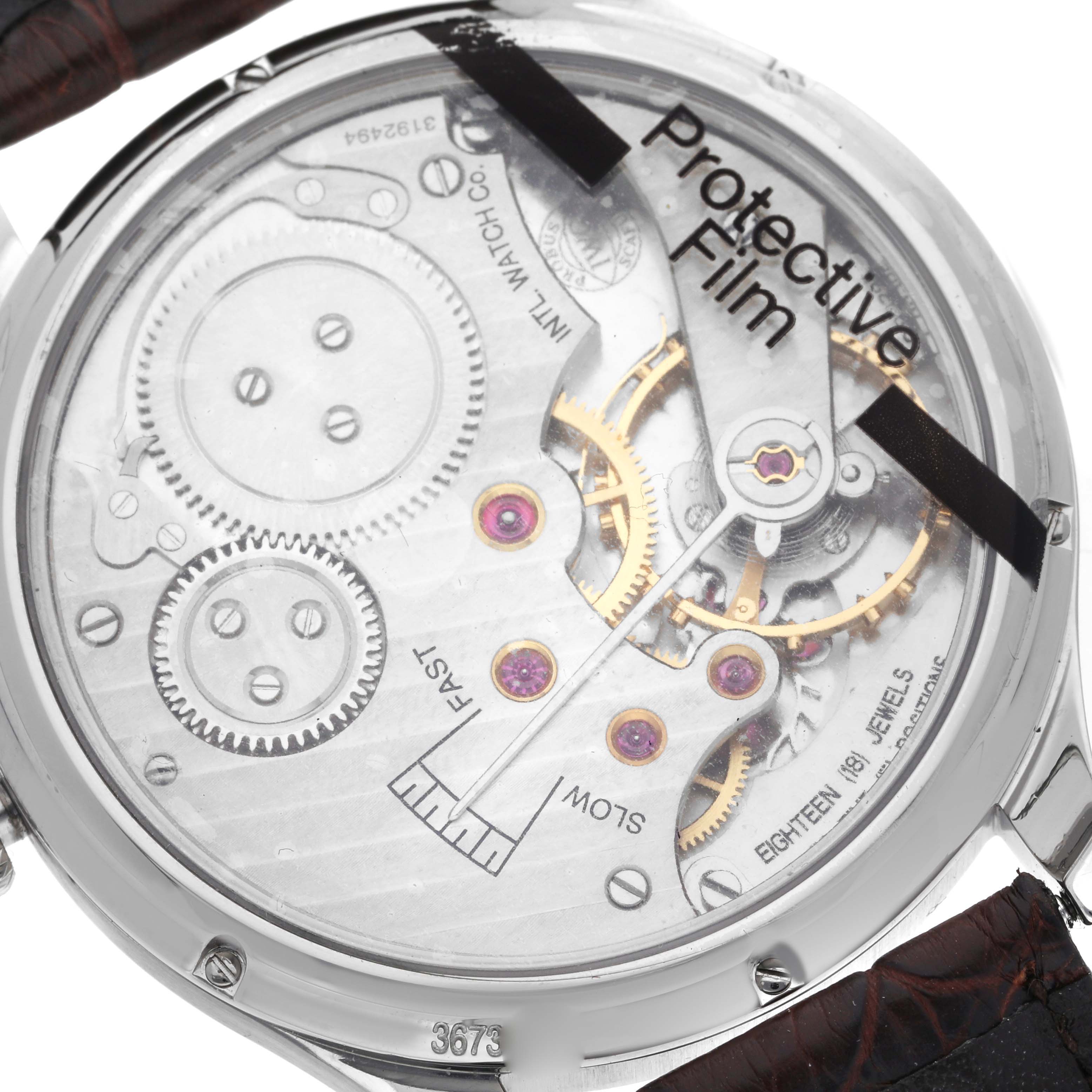 The image shows the back of the IWC Portuguese IW545408 Men's Stainless Steel Silver Dial IW545408 Men's Stainless Steel Silver Dial watch, highlighting its intricate mechanical movement and gears.