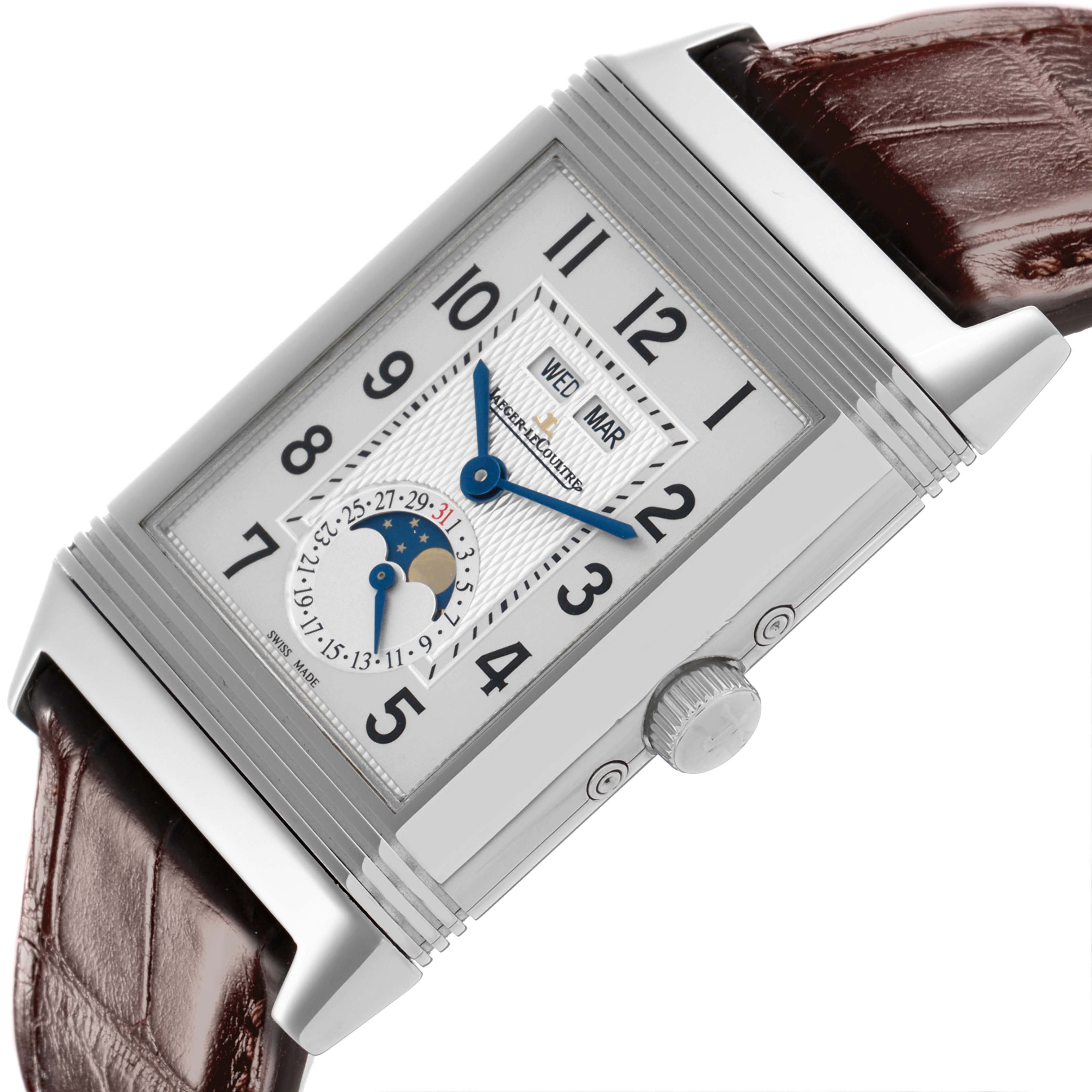 The Jaeger-LeCoultre Reverso watch is shown at an angle displaying the face, hands, crown, and part of the leather strap.