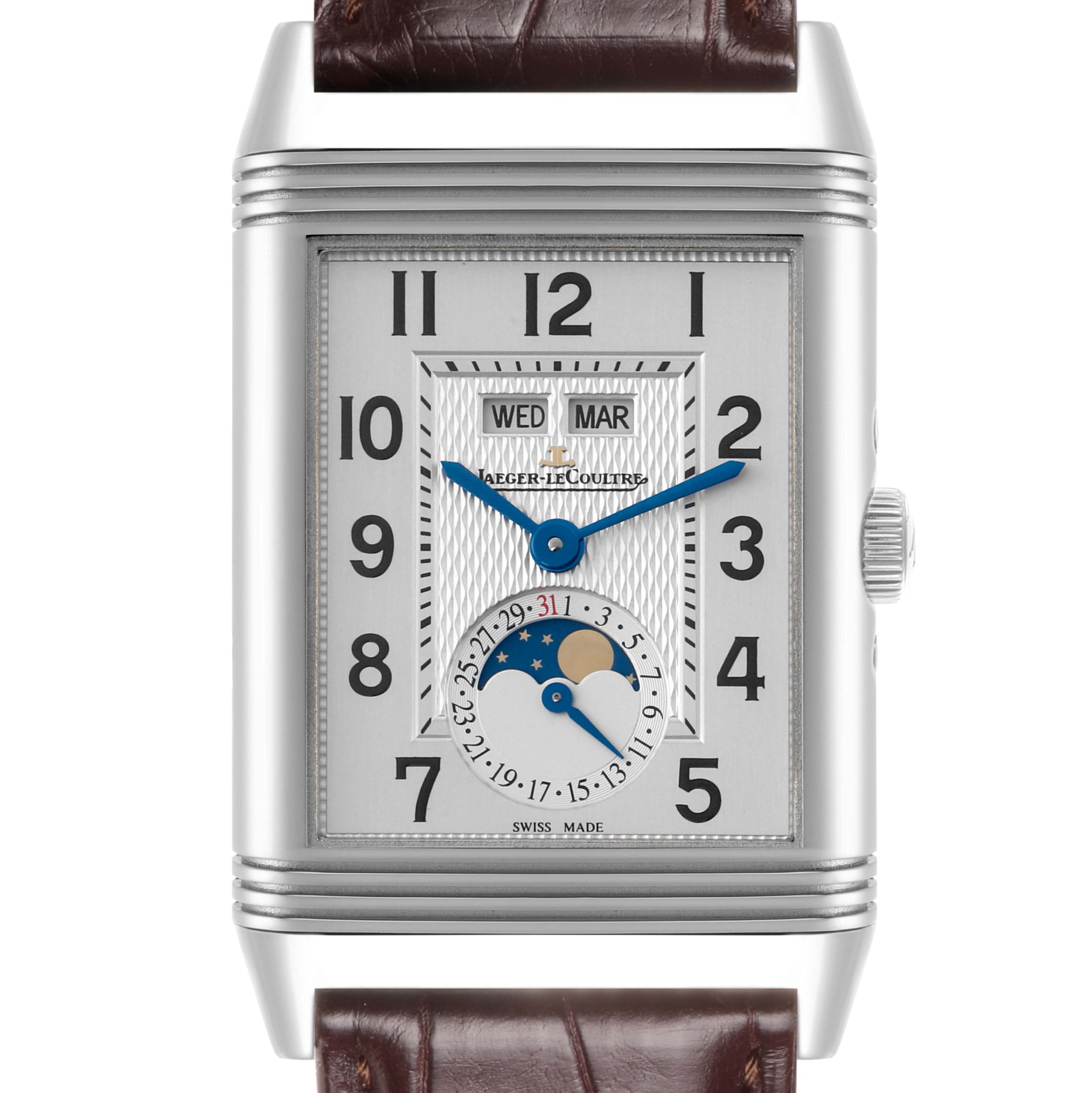 The Jaeger-LeCoultre Reverso watch is shown from a front angle, featuring the dial, hands, and calendar complications.