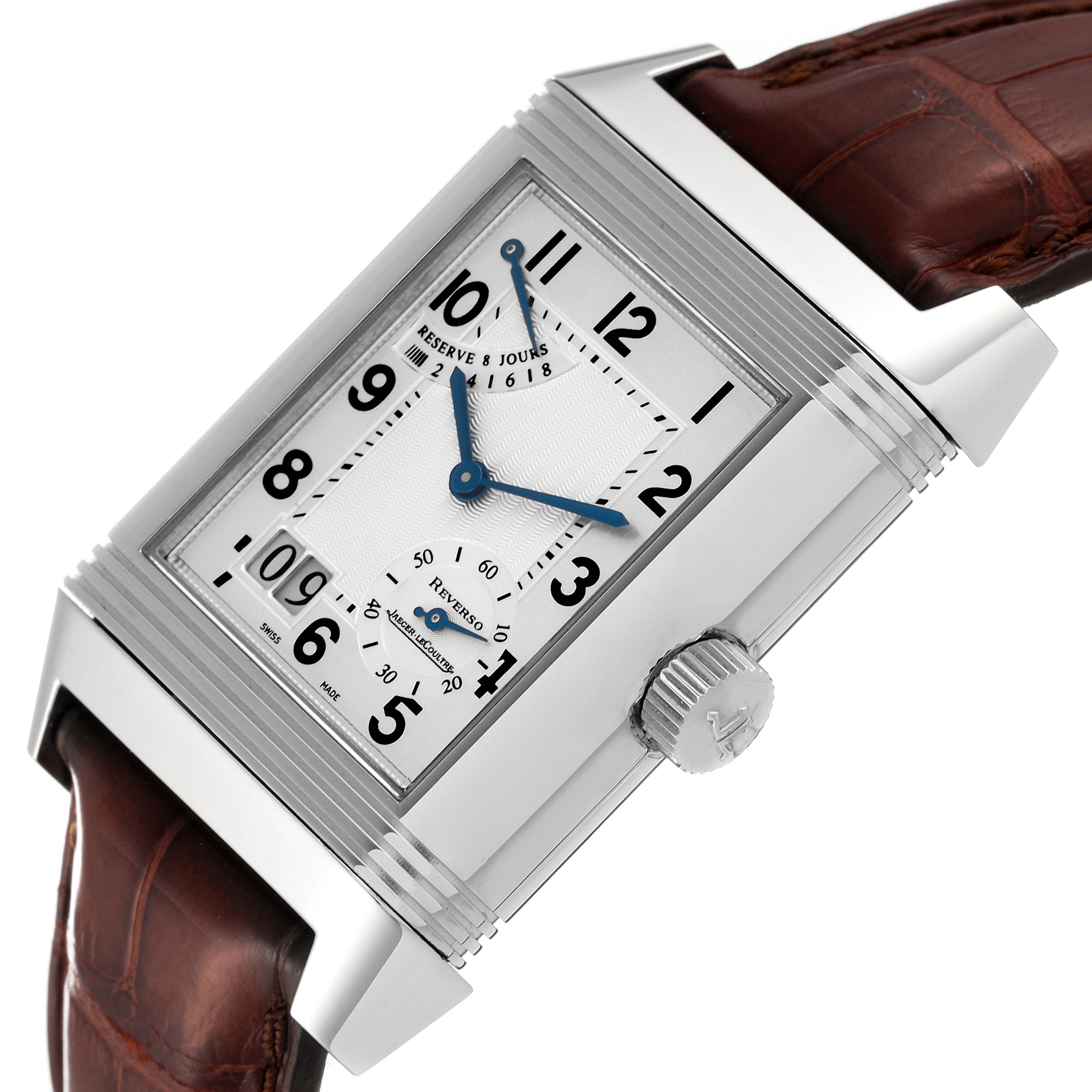 The image shows a close-up angle of a Jaeger-LeCoultre Reverso watch, highlighting the face, crown, and brown leather strap.