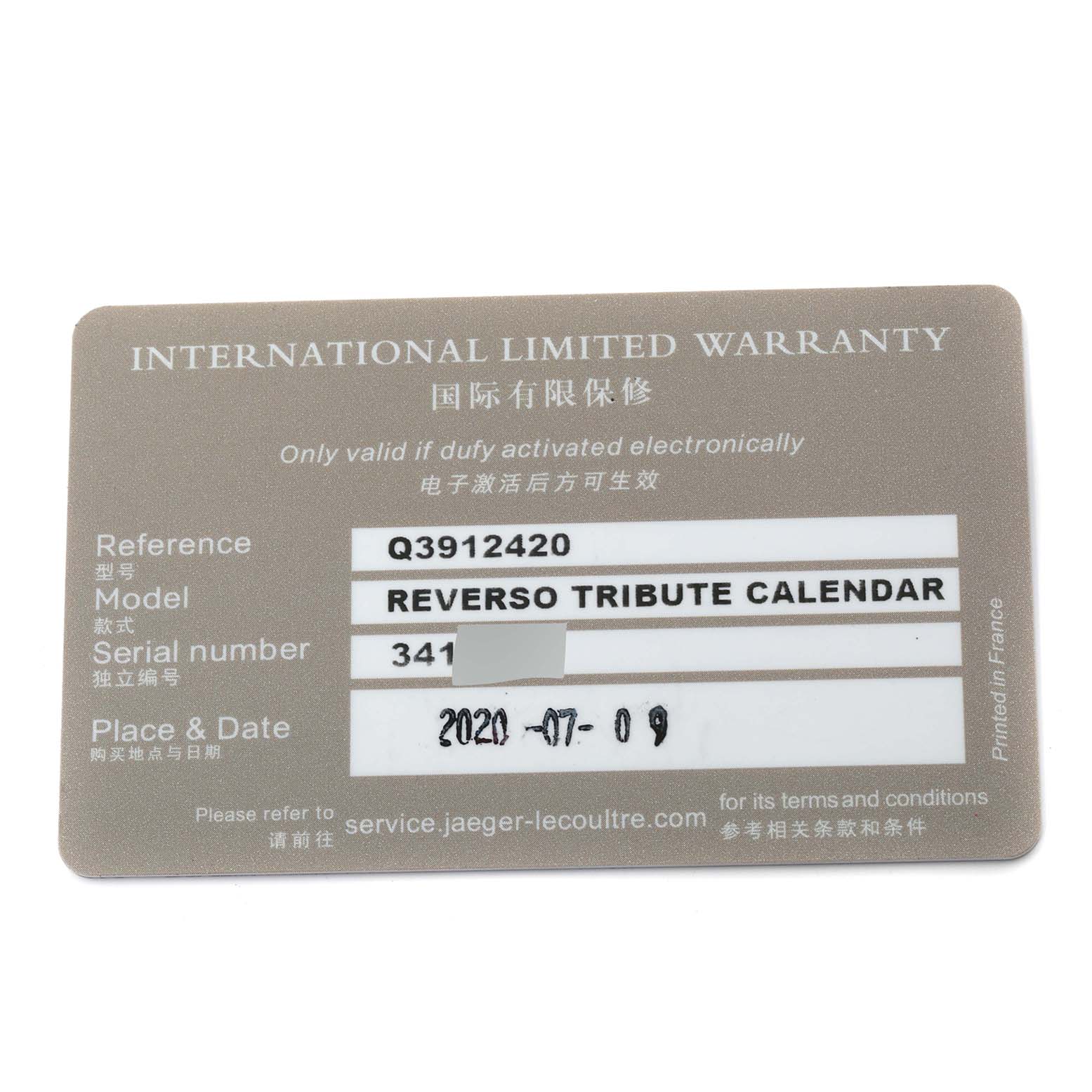 The image shows the warranty card for the Jaeger LeCoultre Reverso Q3912420 Men's Steel and Gold (two tone) Silver Dial Q3912420 Men's Steel and Gold (two tone) Silver Dial Tribute Calendar watch from a top-down angle.
