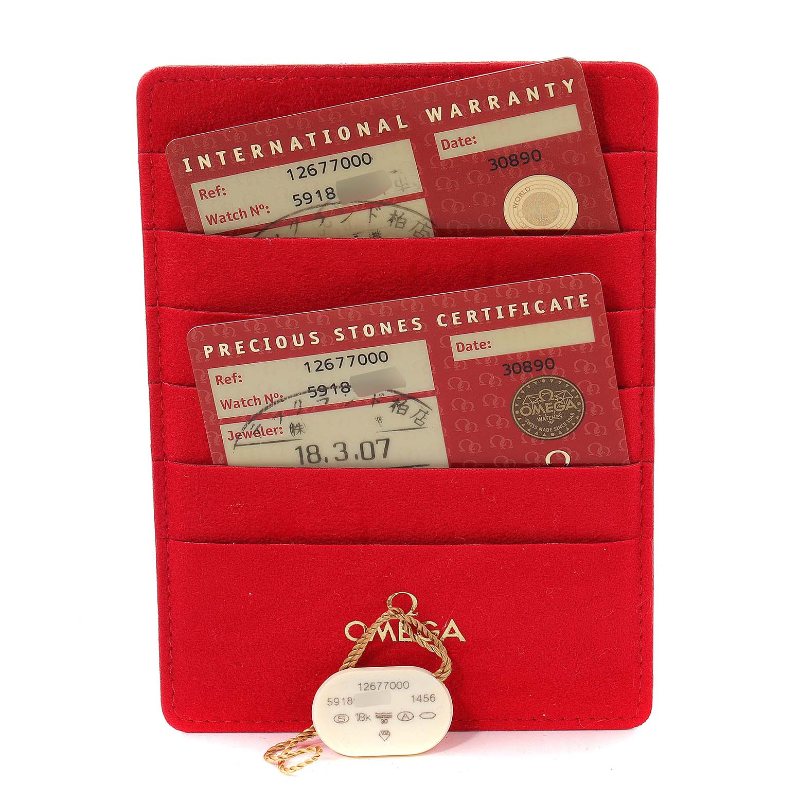 This image shows the warranty cards and a tag for the Omega 1267.70.00 Women
s Steel and Gold (two tone) Mother of Pearl Dial 1267.70.00 Women
s Steel and Gold (two tone) Mother of Pearl Dial Constellation Steel Yellow Gold MOP Diamond Watch model 1267.70.00.