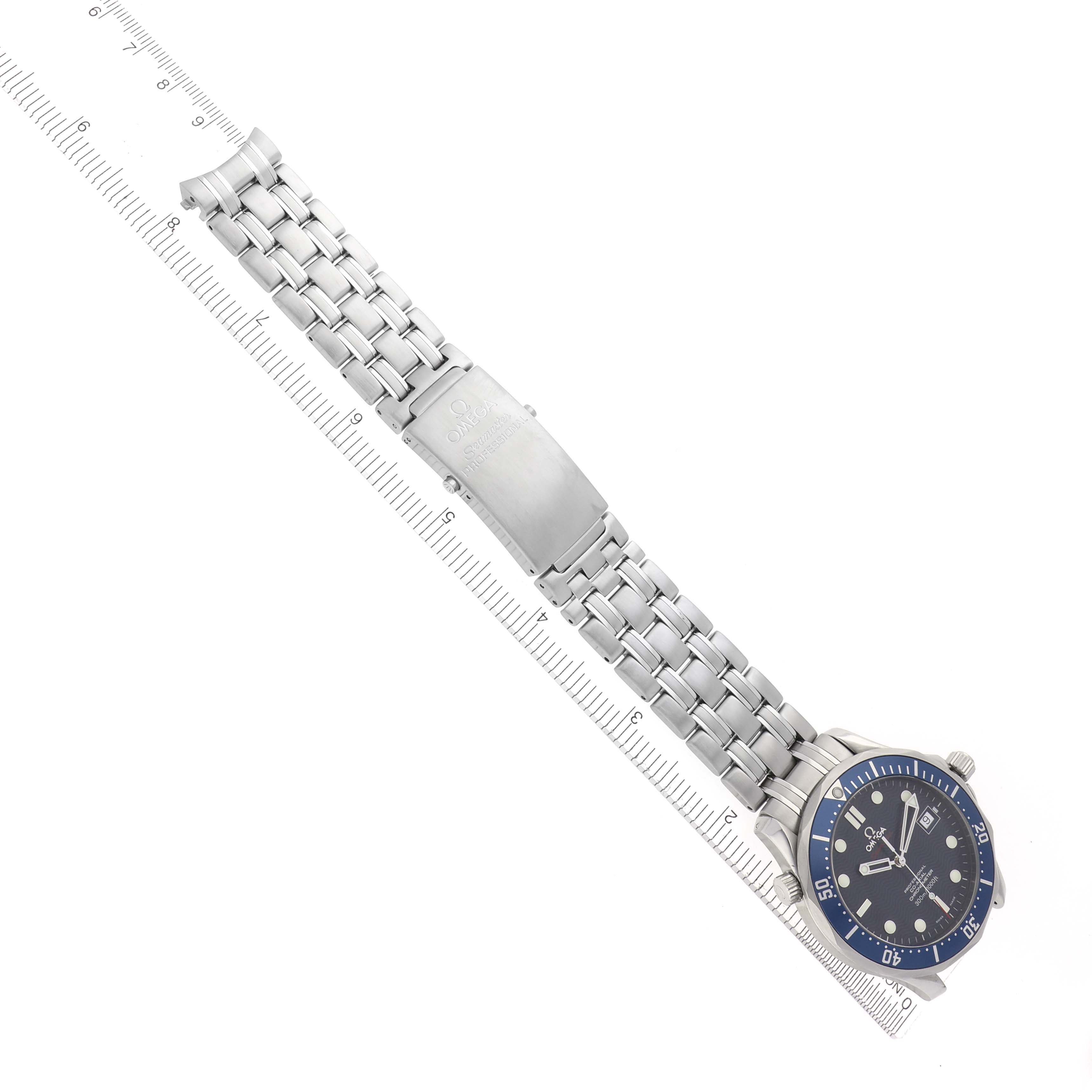 The Omega Seamaster 2220.80.00 Men
s Stainless Steel Blue Dial 2220.80.00 Men
s Stainless Steel Blue Dial watch is shown at an angle displaying the face, bracelet, and clasp alongside a ruler for scale.