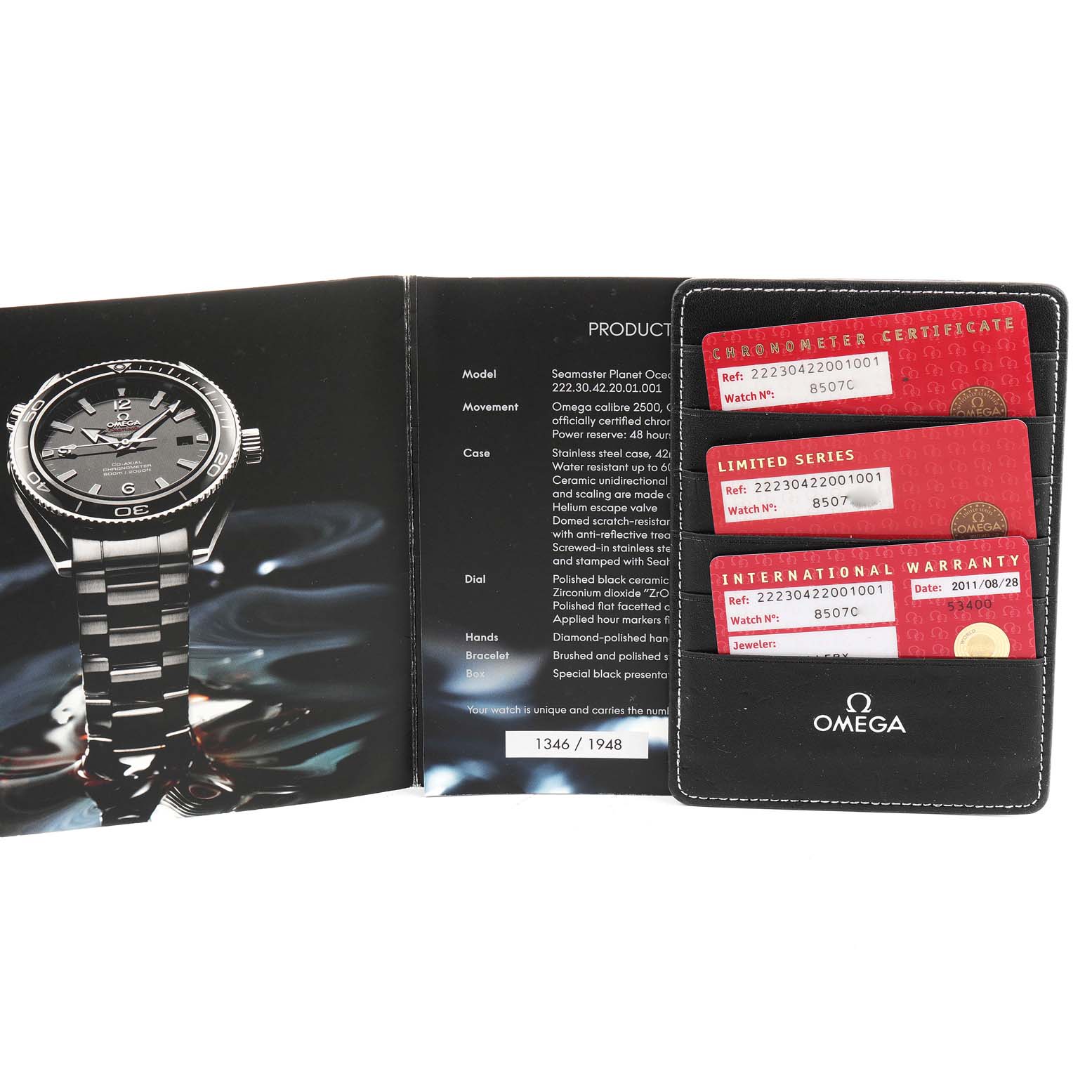 The image shows a Planet Ocean model by Omega from the front, along with its warranty cards and booklet.