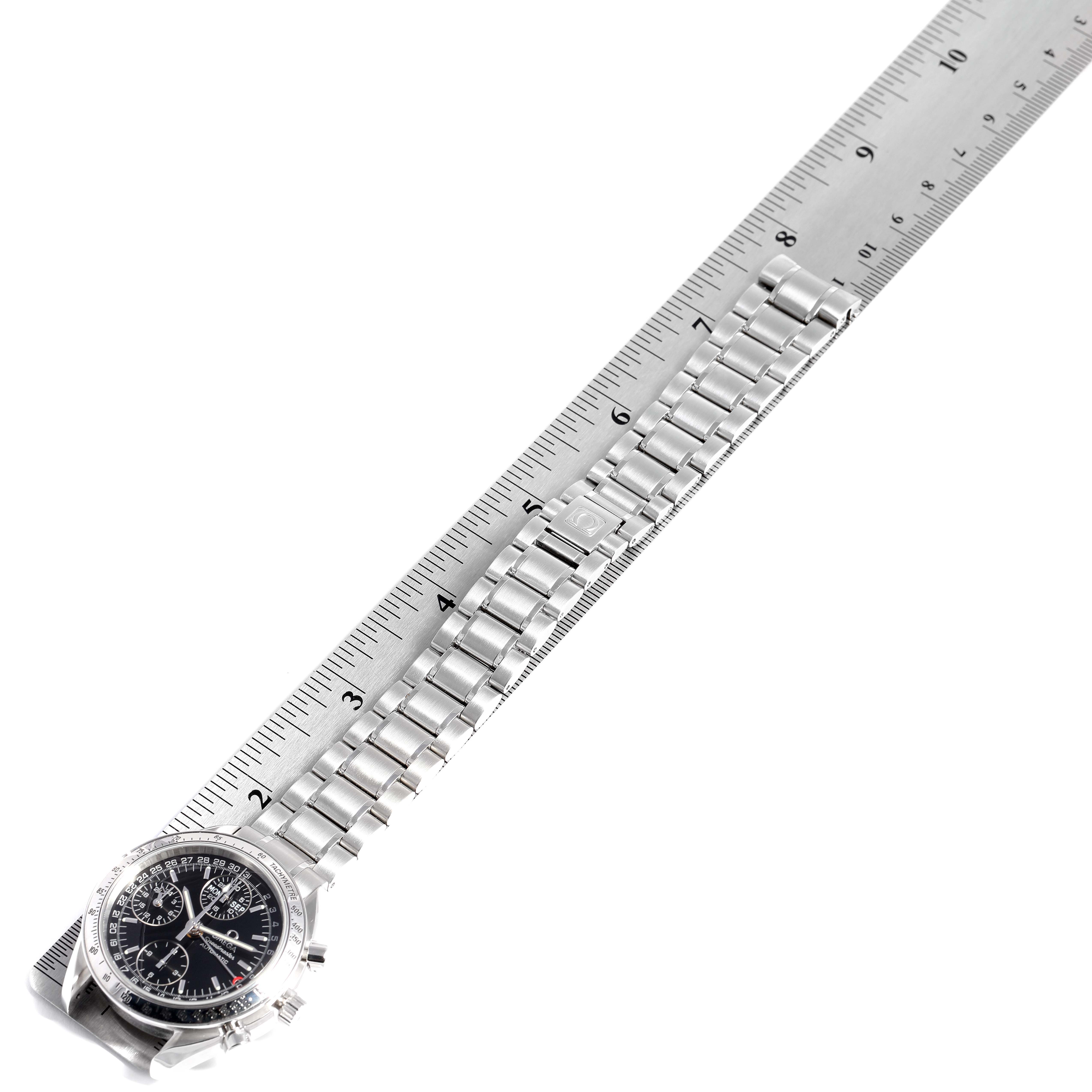 This image shows an Omega Speedmaster 3523.50.00 Men
s Stainless Steel Black Dial 3523.50.00 Men
s Stainless Steel Black Dial watch diagonally laid alongside a ruler, highlighting the watch face and metal strap.