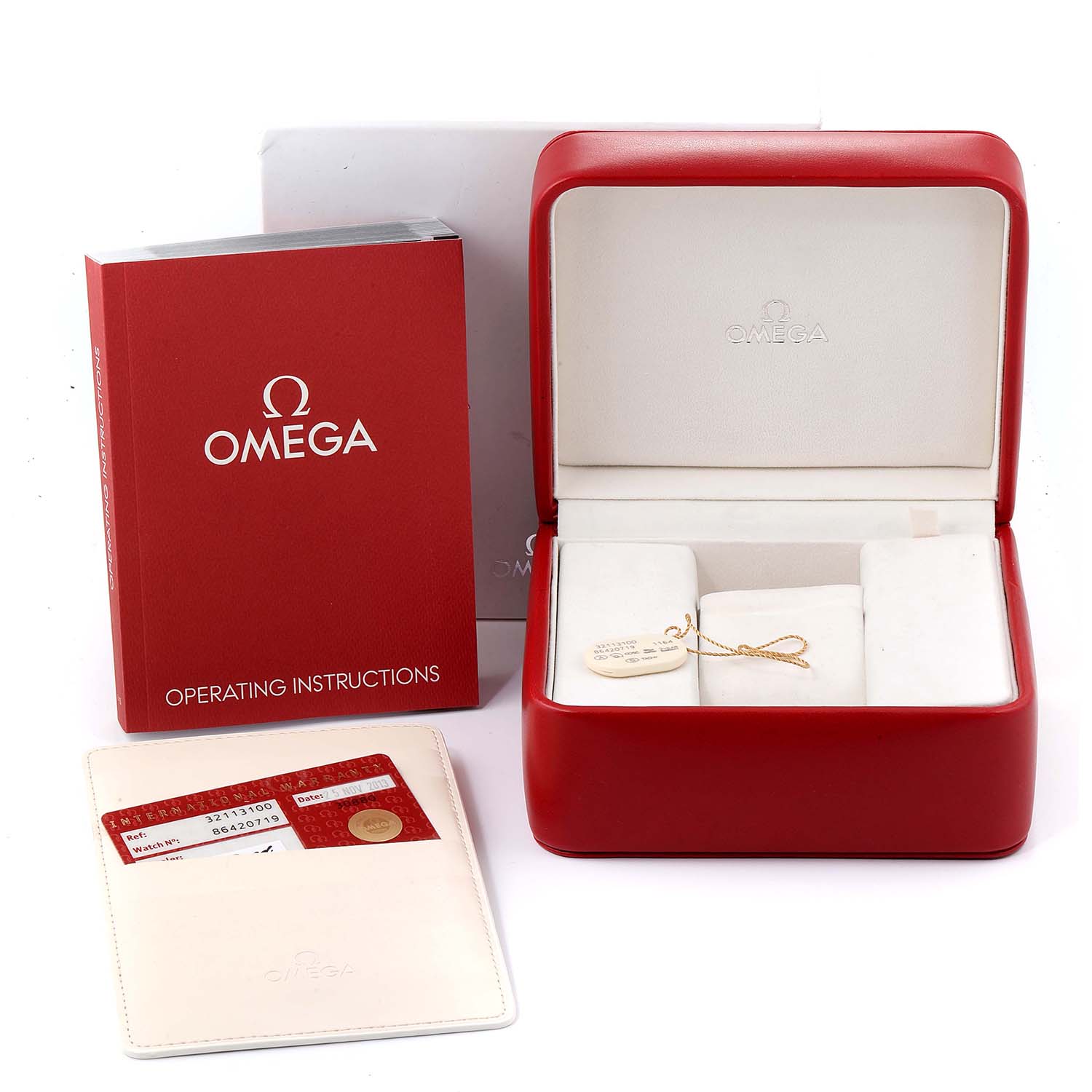 The image shows the Omega Speedmaster 3211.31.00 Men's Stainless Steel Silver Dial 3211.31.00 Men's Stainless Steel Silver Dial's case, instruction manual, and warranty card.