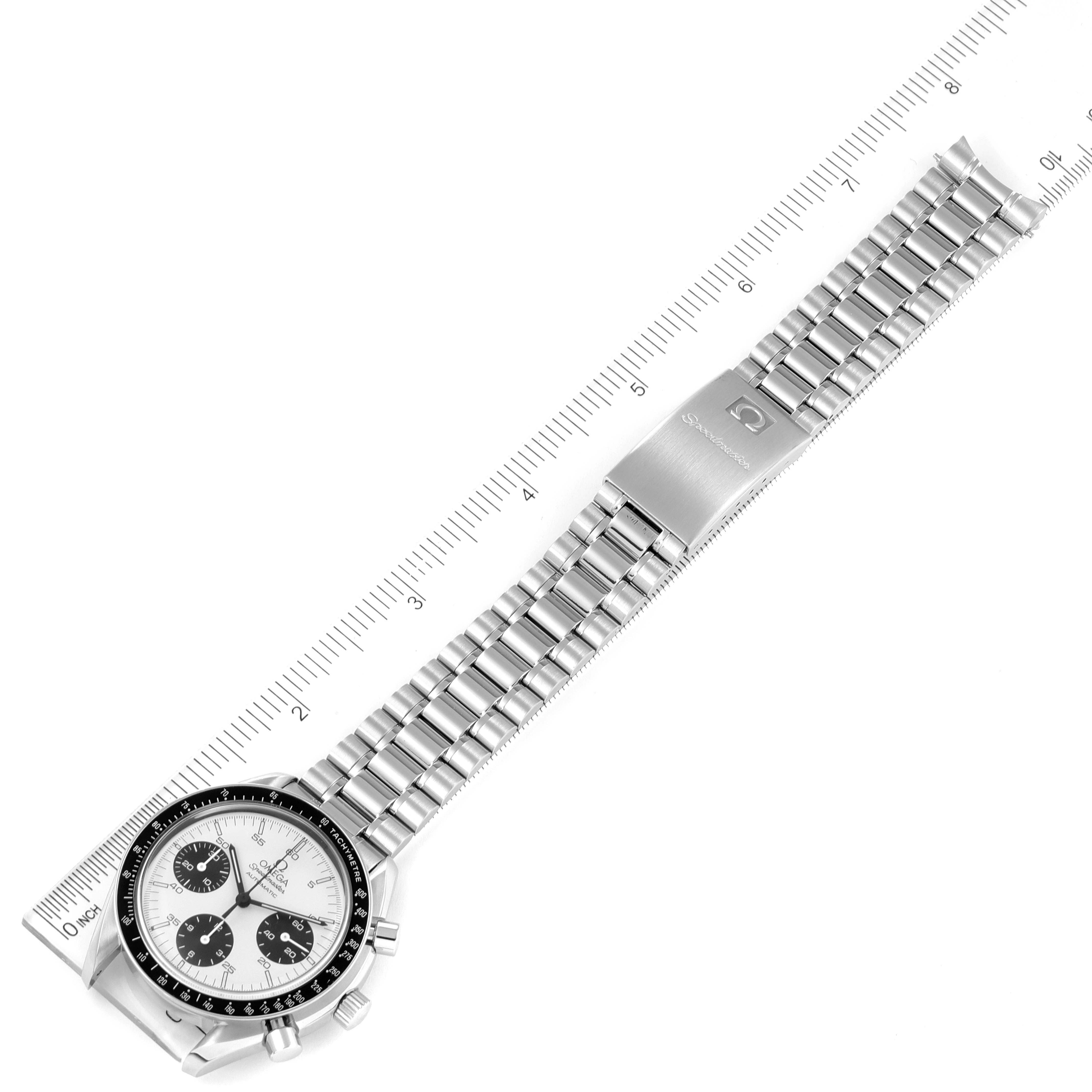 The Omega Speedmaster 3510.21.00 Men's Stainless Steel Silver Dial 3510.21.00 Men's Stainless Steel Silver Dial watch is shown fully extended, with a metal bracelet and clasp visible, set against a ruler for measurement.