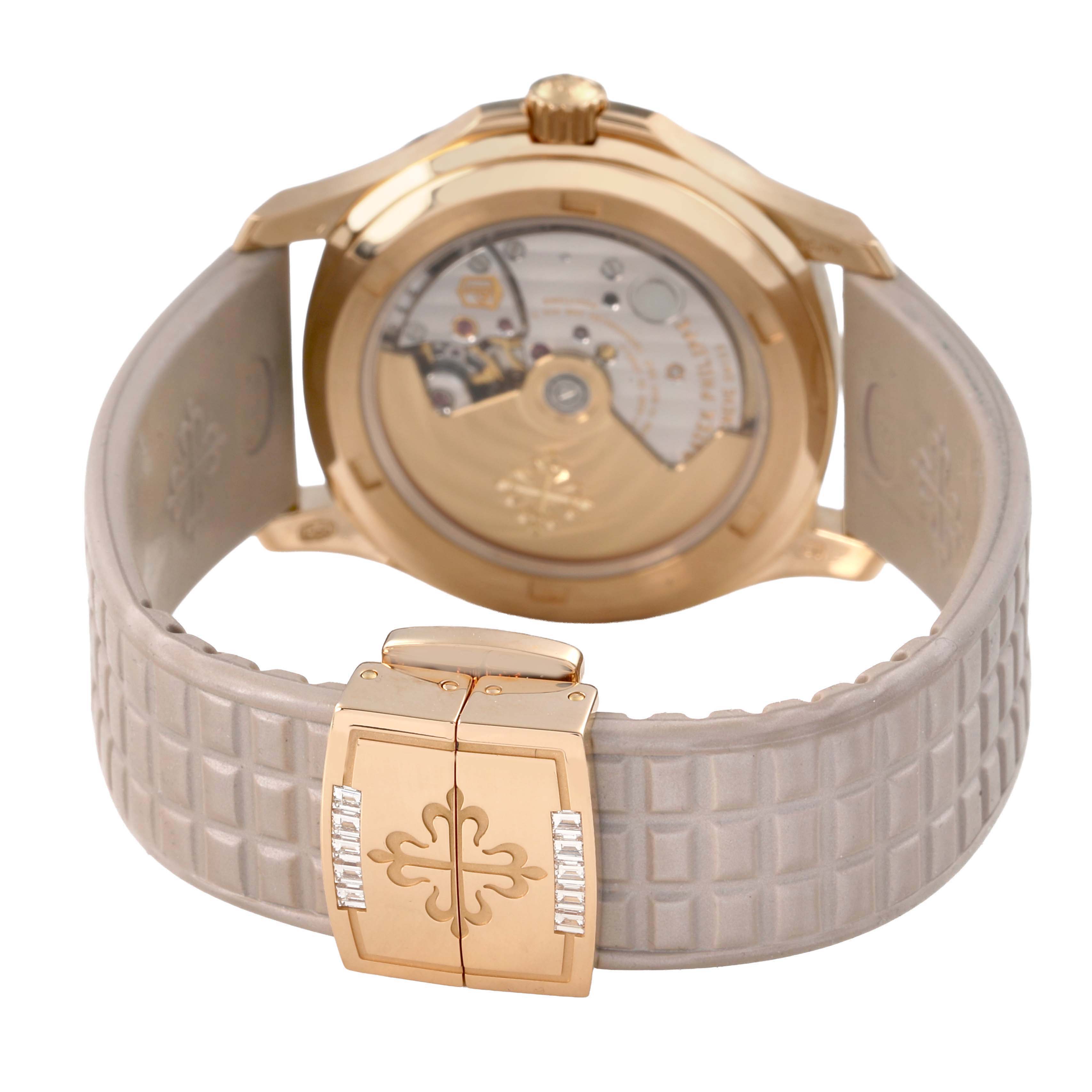 The Patek Philippe Aquanaut 5072R-001 Women's Rose Gold Mother of Pearl Dial watch is shown from the back, highlighting the transparent case back and intricate clasp design.