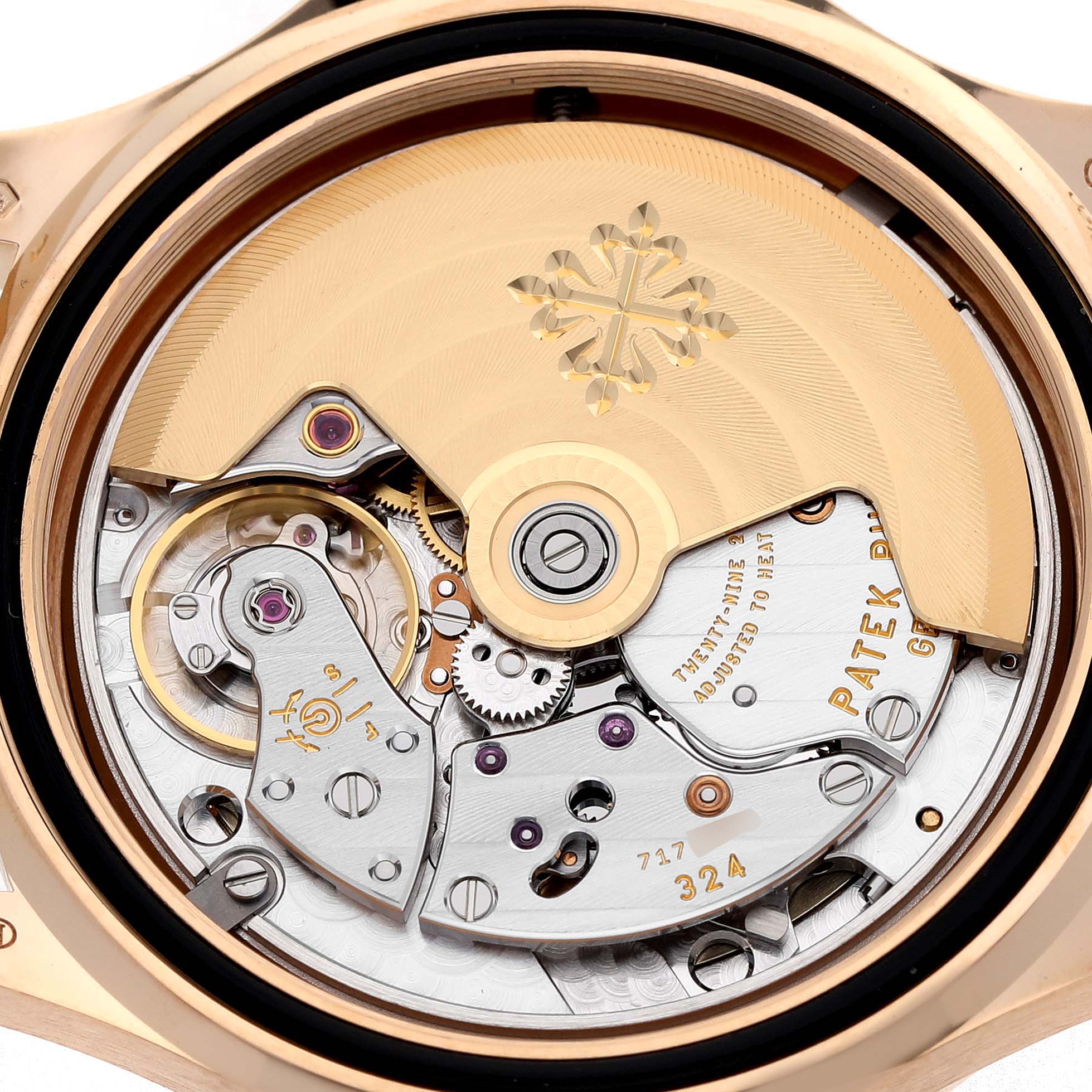 This image shows the movement of a Patek Philippe Aquanaut 5072R-001 Women's Rose Gold Mother of Pearl Dial watch from the back, highlighting the intricate gears and rotor.
