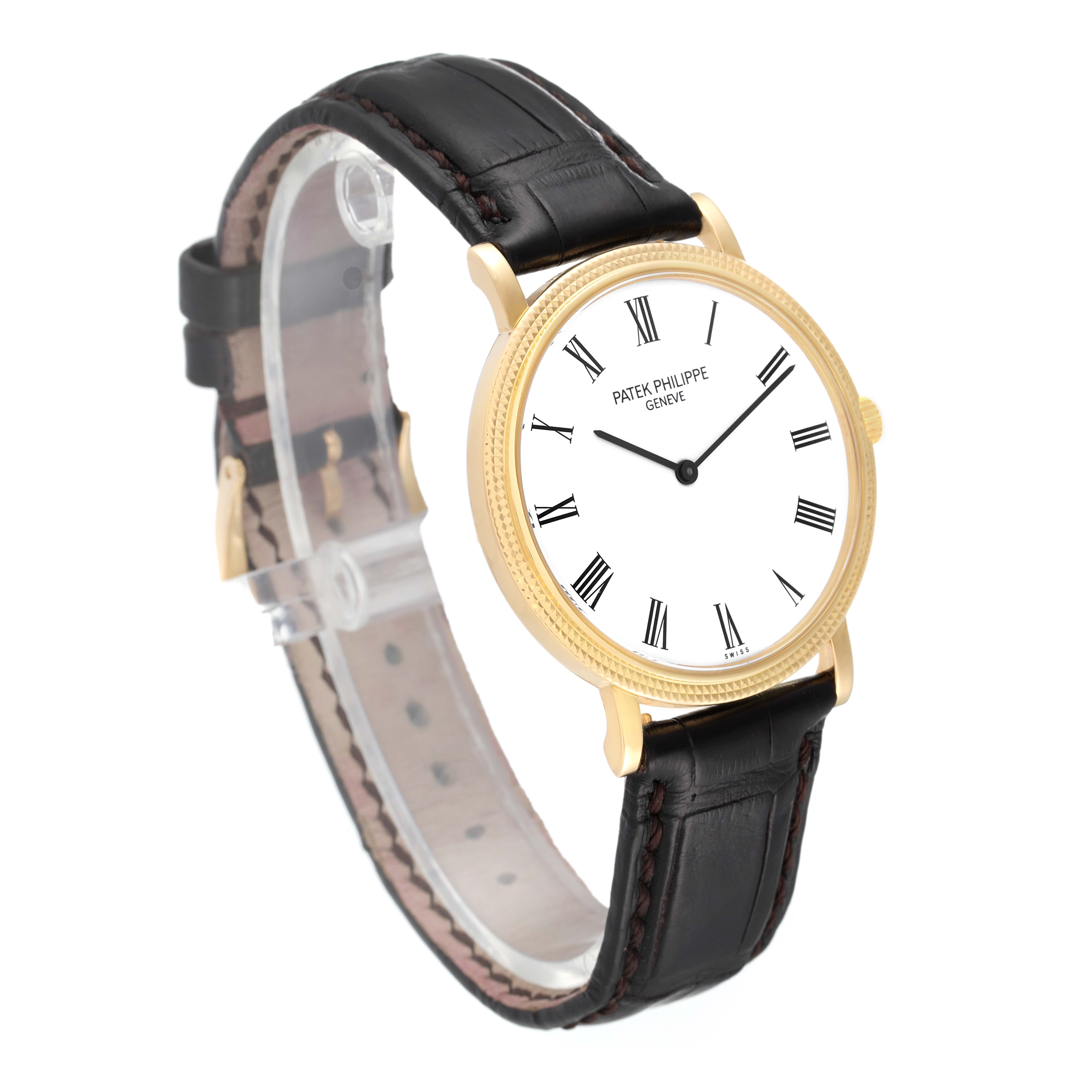 The image shows a Patek Philippe Calatrava 5120J Men
s Yellow Gold White Dial 5120J Men
s Yellow Gold White Dial watch from a front angle, featuring a black leather strap and a white dial with Roman numerals.