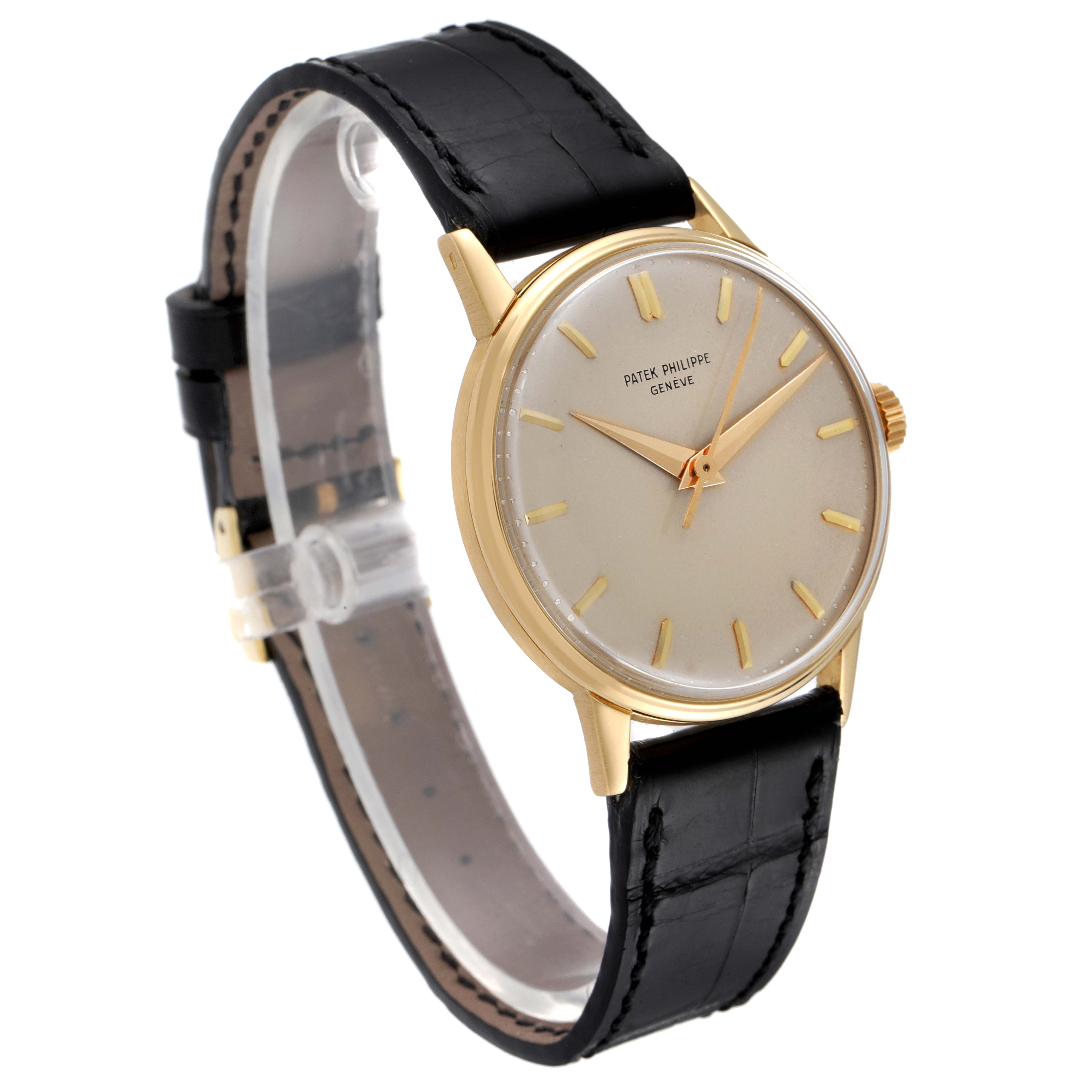 The image shows a side-angle view of a Vintage Patek Philippe watch, including the gold case, dial, hands, and black leather strap.