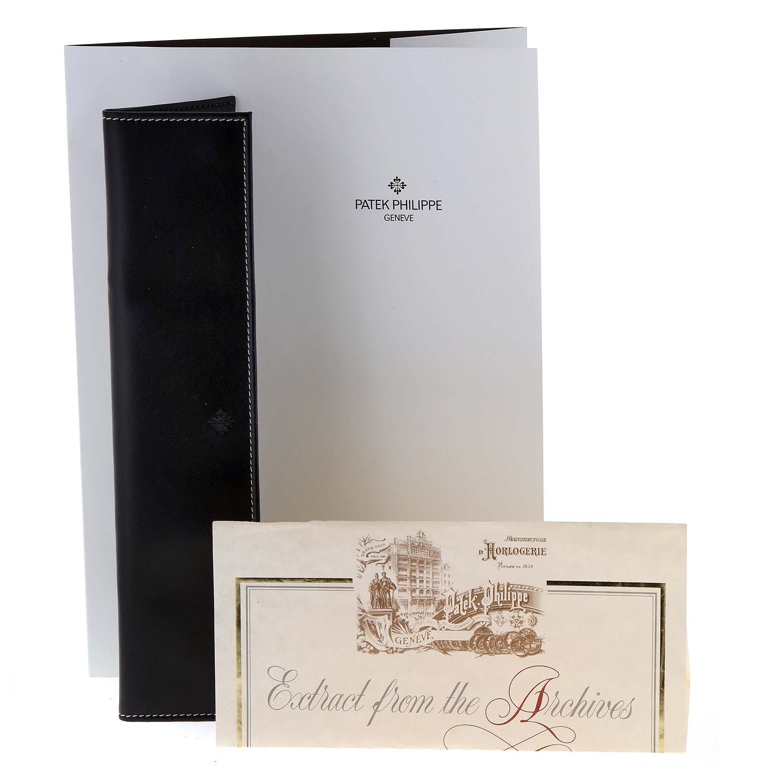 The image shows the accessories of a Vintage model by Patek Philippe, including a document folder and an "Extract from the Archives" booklet.