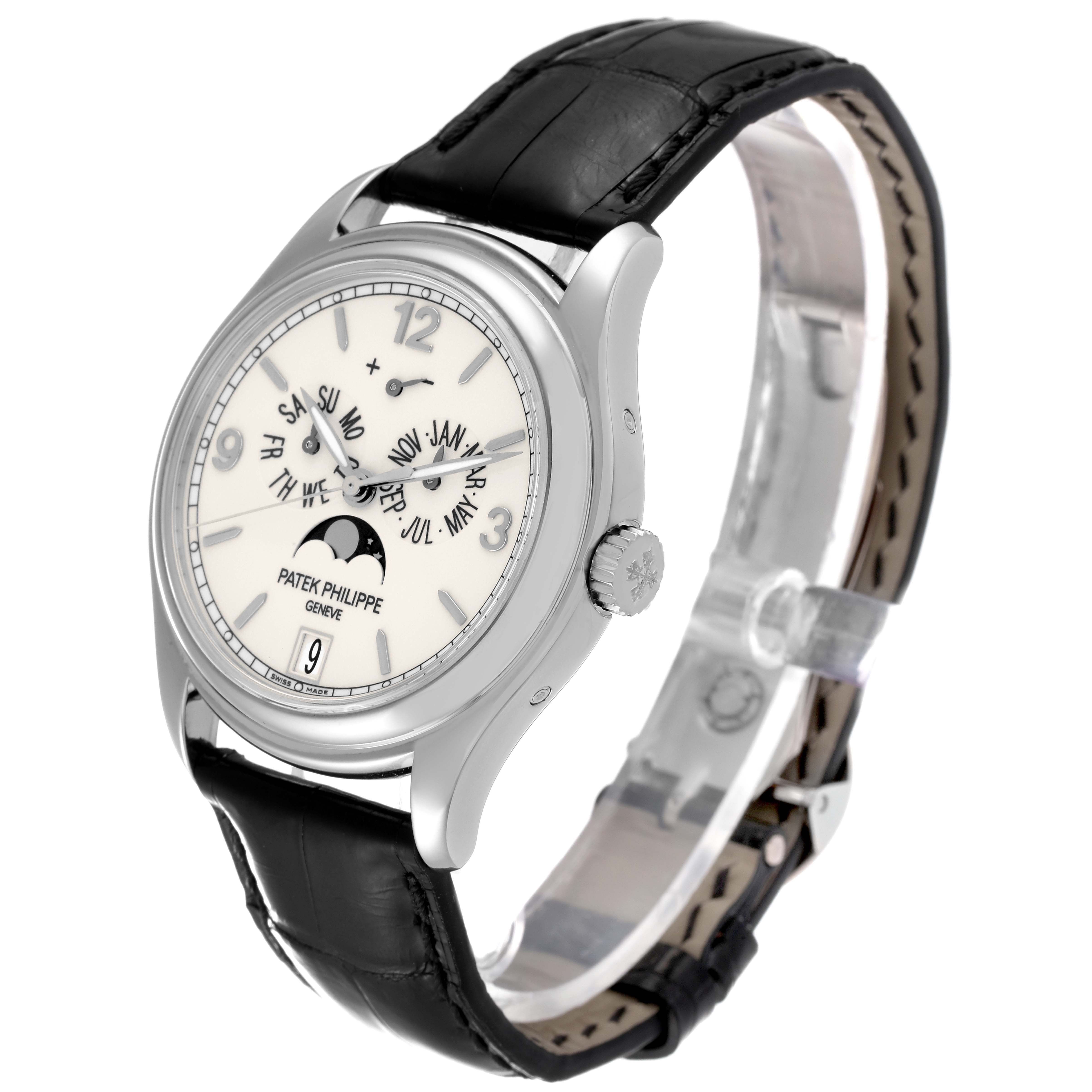 The image displays a Patek Philippe Complications 5146G-001 Men's White Gold Beige Dial 5146G-001 Men's White Gold Beige Dial model watch from a front-side angle, showcasing its dial, crown, and leather strap.