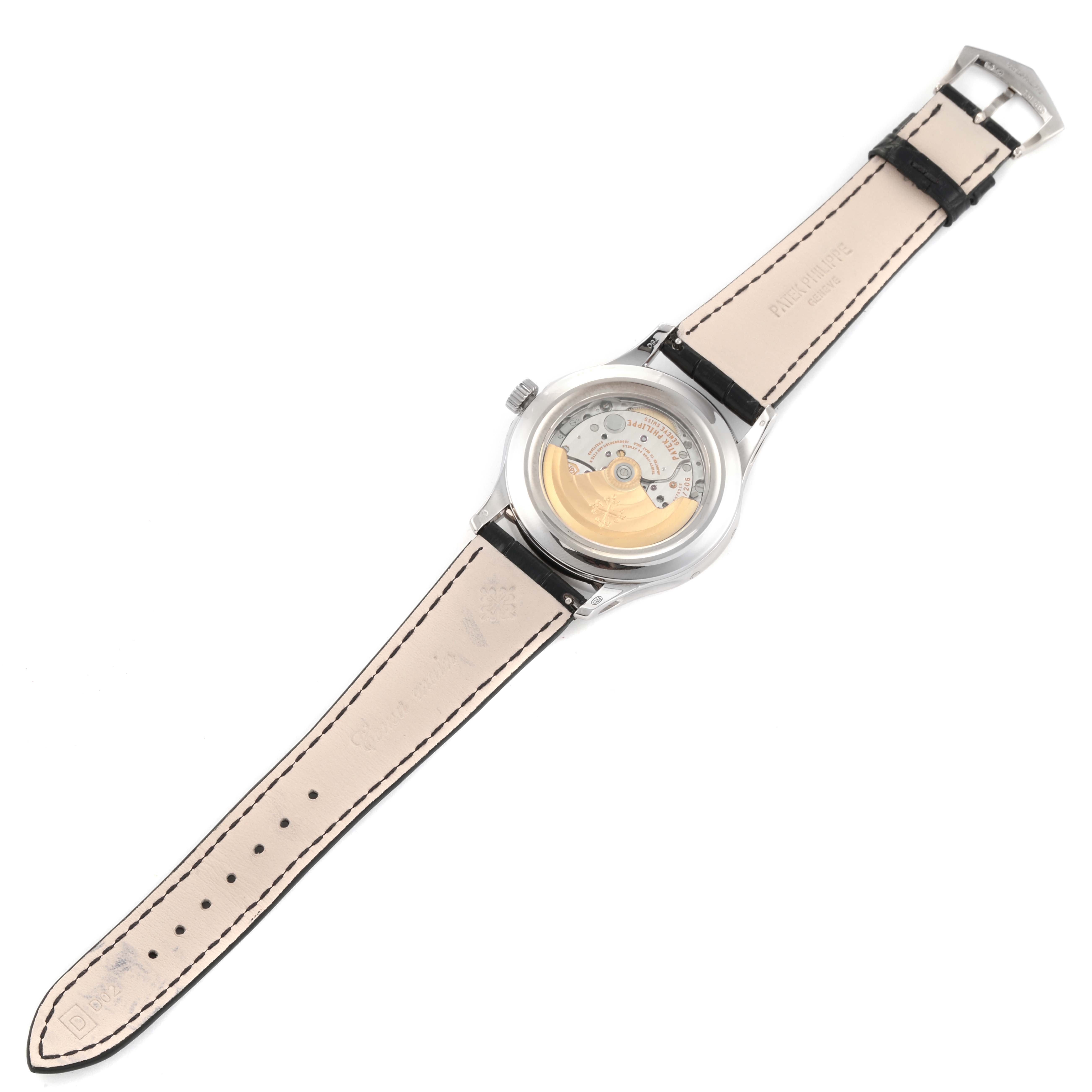 The image shows the back view of a Patek Philippe Complications 5205G-001 Men's White Gold Silver Dial 5205G-001 Men's White Gold Silver Dial model watch, displaying its intricate movement and leather strap.