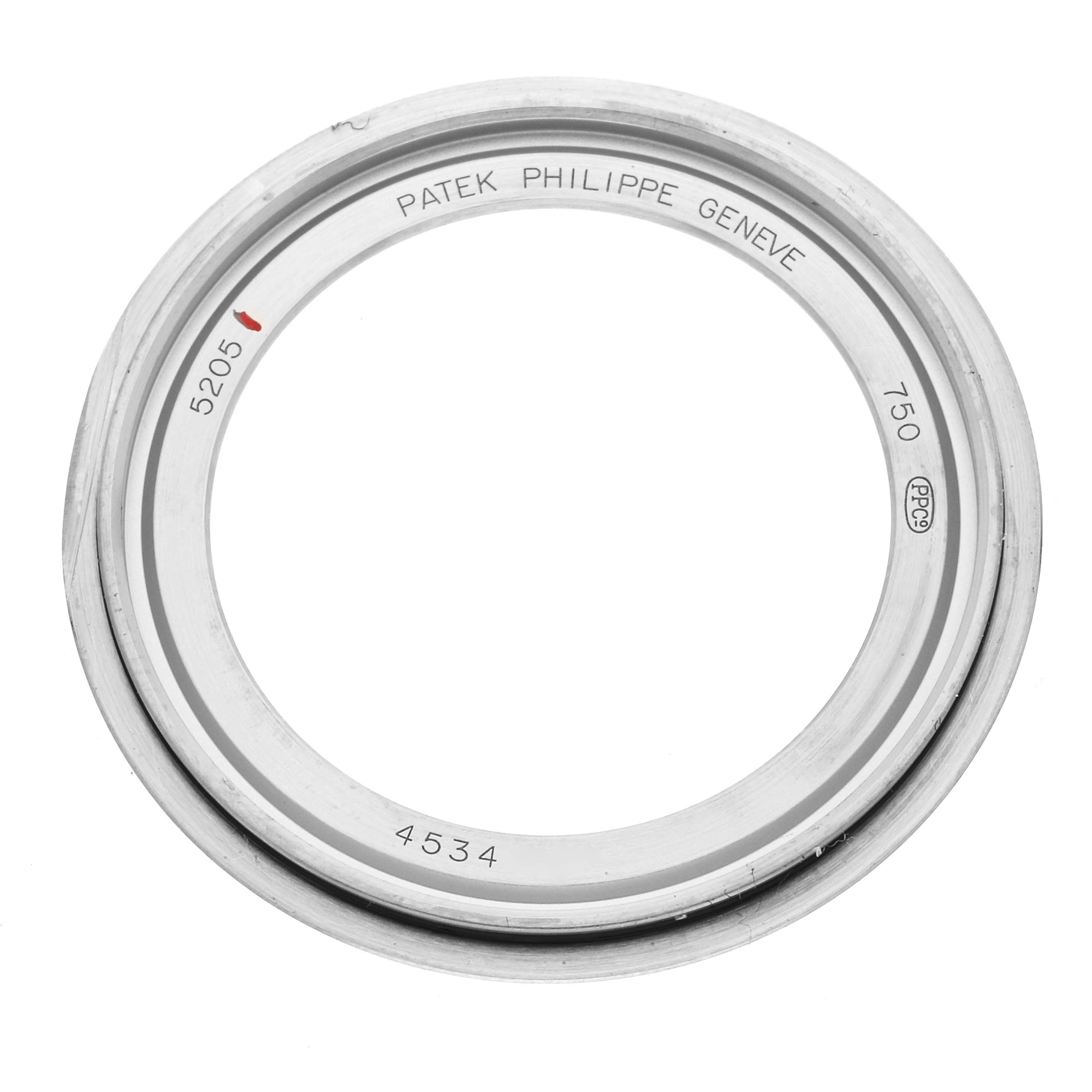 The image shows the bezel or ring from a Patek Philippe Complications 5205G-001 Men's White Gold Silver Dial 5205G-001 Men's White Gold Silver Dial model 5205, presented from a top-down angle.