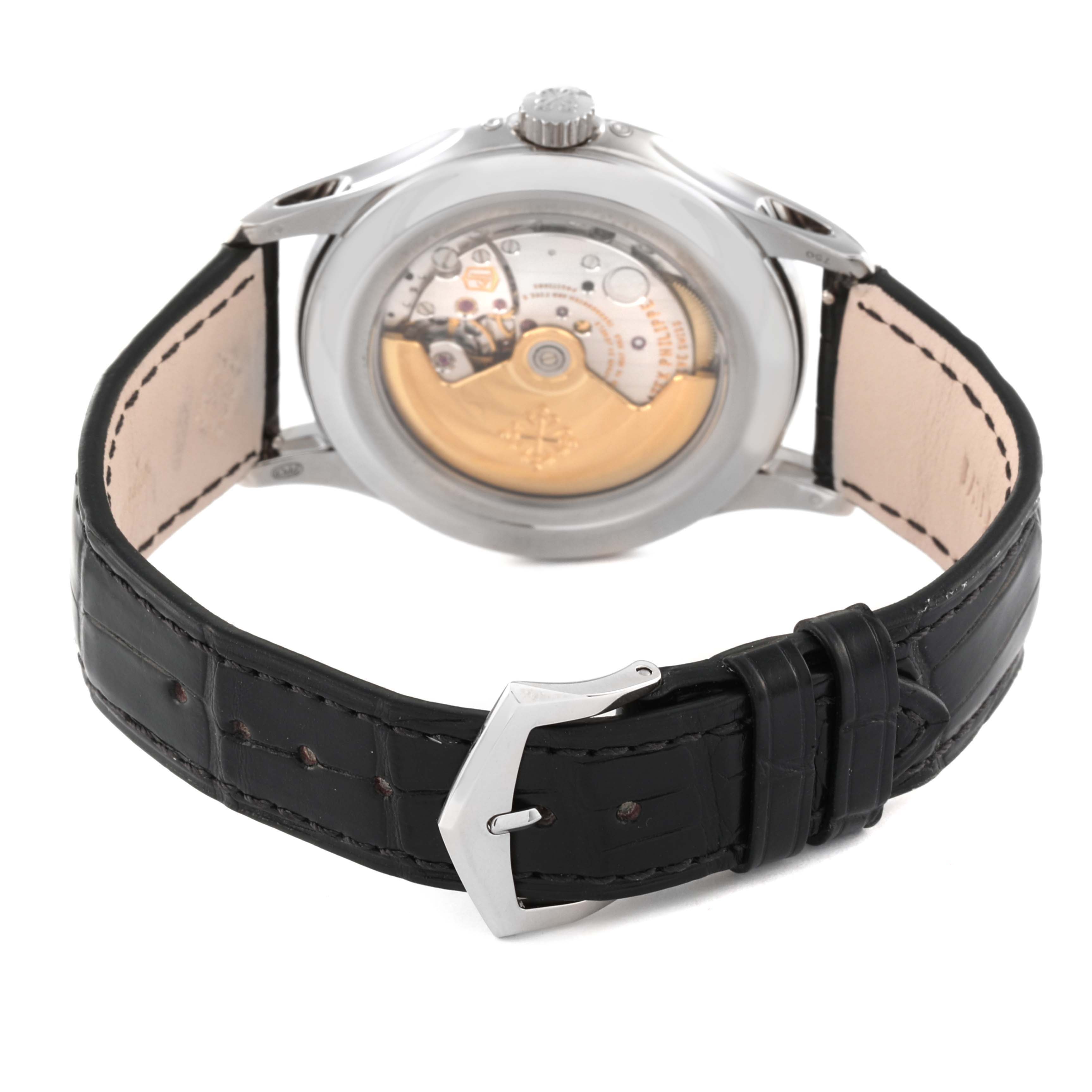 The image shows the back view of a Patek Philippe Complications 5205G-001 Men's White Gold Silver Dial 5205G-001 Men's White Gold Silver Dial watch, highlighting its movement and black leather strap.