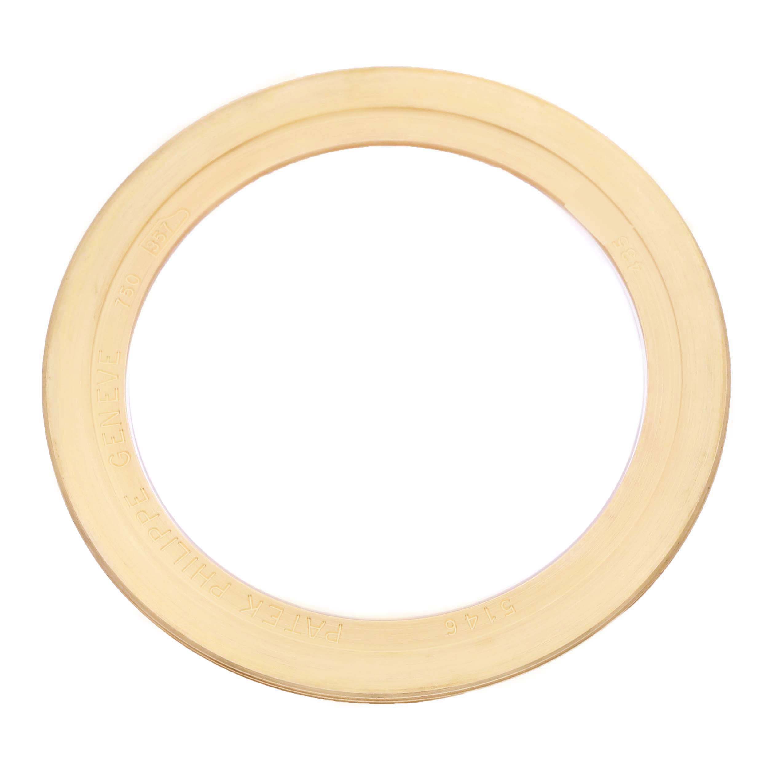 The image shows a gold bezel viewed from a top-down angle for the Patek Philippe Complications 5146J-010 Men's Yellow Gold Grey Dial model.