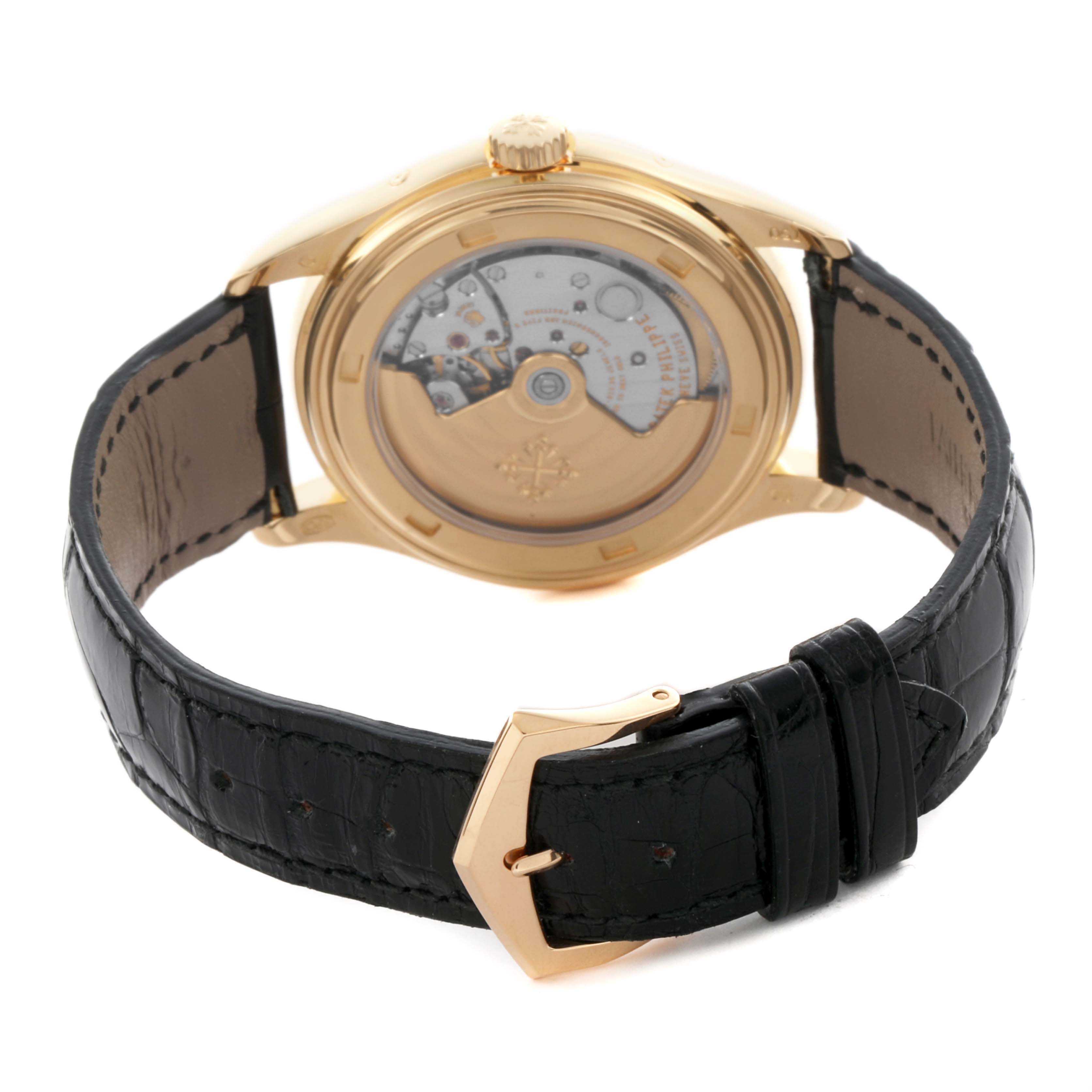 This image shows the back view of a Patek Philippe Complications 5146J-010 Men's Yellow Gold Grey Dial 5146J-010 Men's Yellow Gold Grey Dial watch, highlighting its movement and gold case with a leather strap.