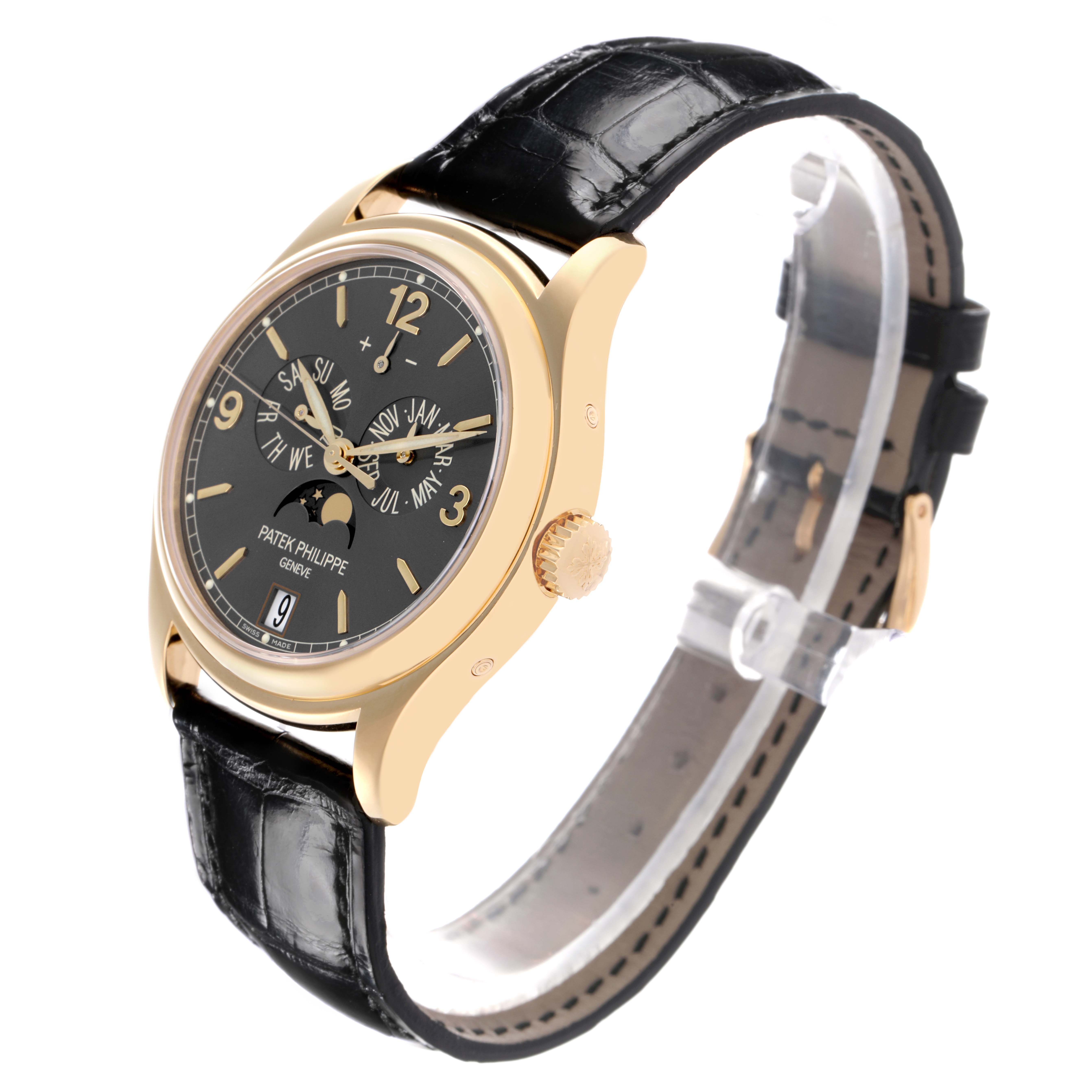 The Patek Philippe Complications 5146J-010 Men's Yellow Gold Grey Dial 5146J-010 Men's Yellow Gold Grey Dial watch is shown at a slight angle, highlighting the gold case, black dial, crown, and leather strap.