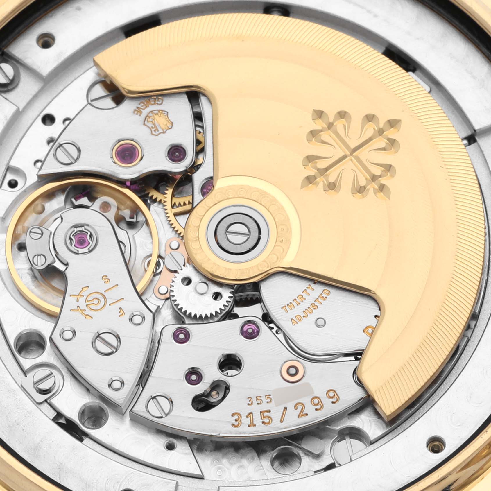 The image shows a close-up of the movement and rotor of a Patek Philippe Complications 5146J-010 Men's Yellow Gold Grey Dial 5146J-010 Men's Yellow Gold Grey Dial watch.