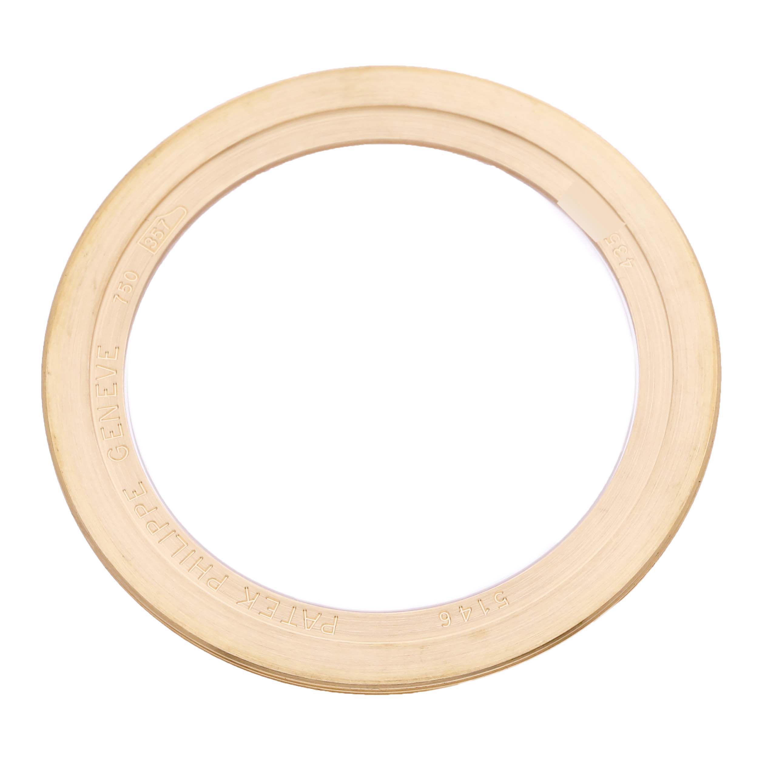 The image shows a circular gold bezel from a Patek Philippe Complications 5146J-010 Men's Yellow Gold Grey Dial 5146J-010 Men's Yellow Gold Grey Dial model, viewed from the top.