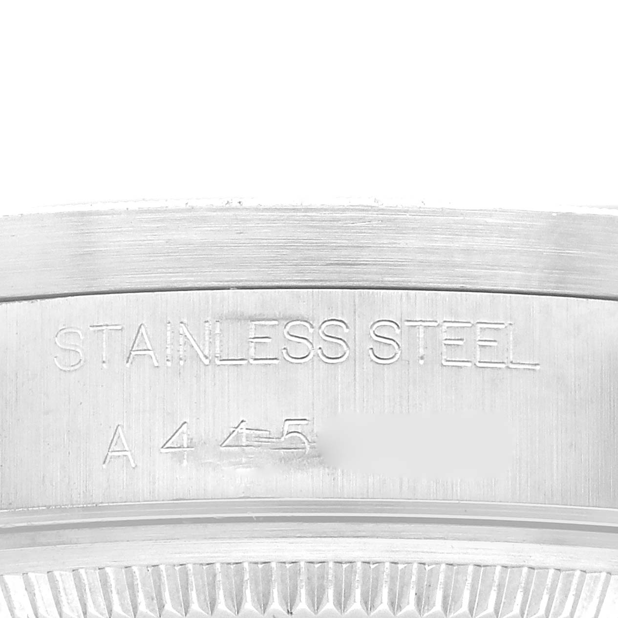 The image shows a close-up of the case back of a Rolex Air-King 14010 Men's Stainless Steel Black Dial 14010 Men's Stainless Steel Black Dial, highlighting the "Stainless Steel" engraving and partial serial number.