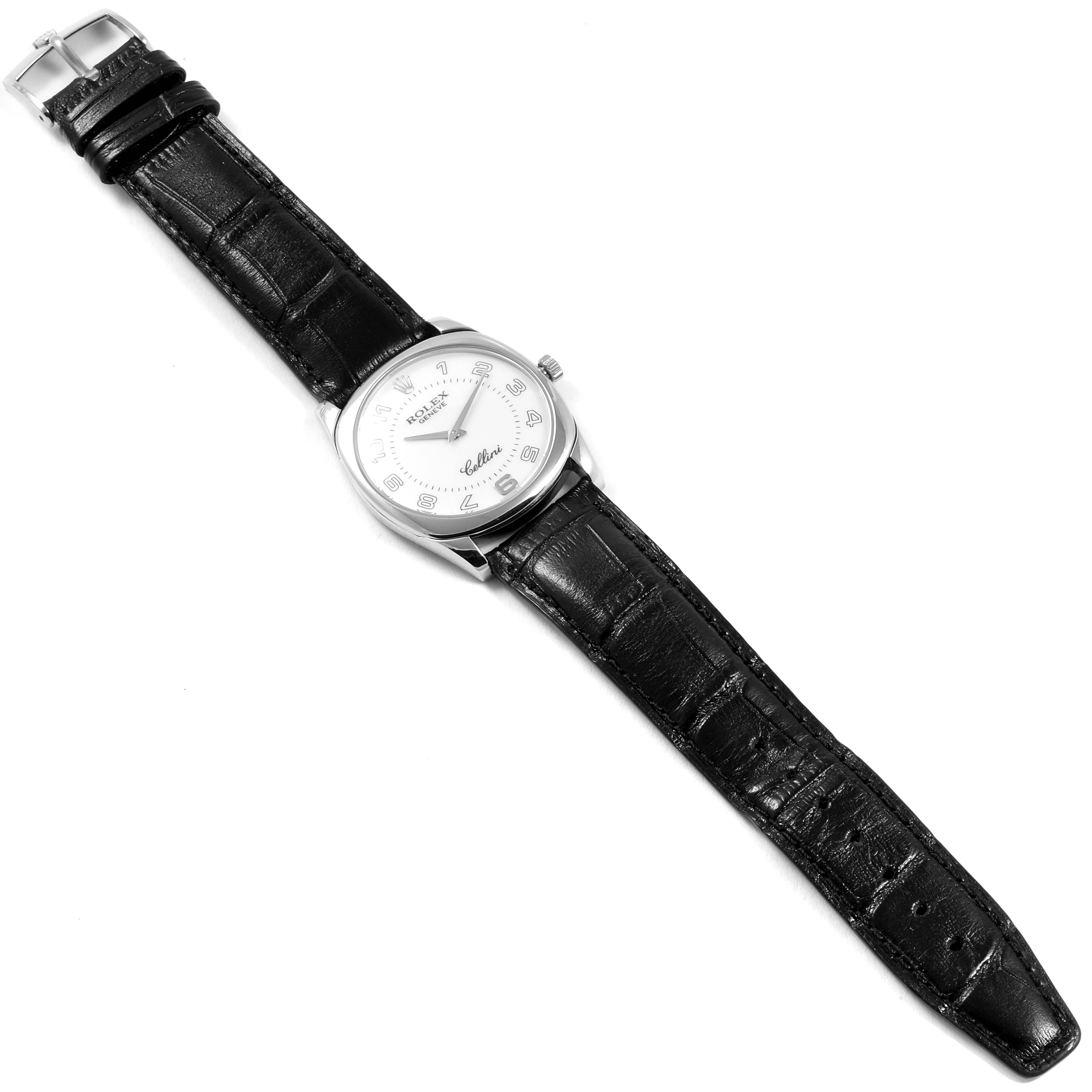 The image shows a top-down view of a Rolex Cellini 4233 Men
s White Gold White Dial 4233 Men
s White Gold White Dial watch with a black leather strap and a silver dial.