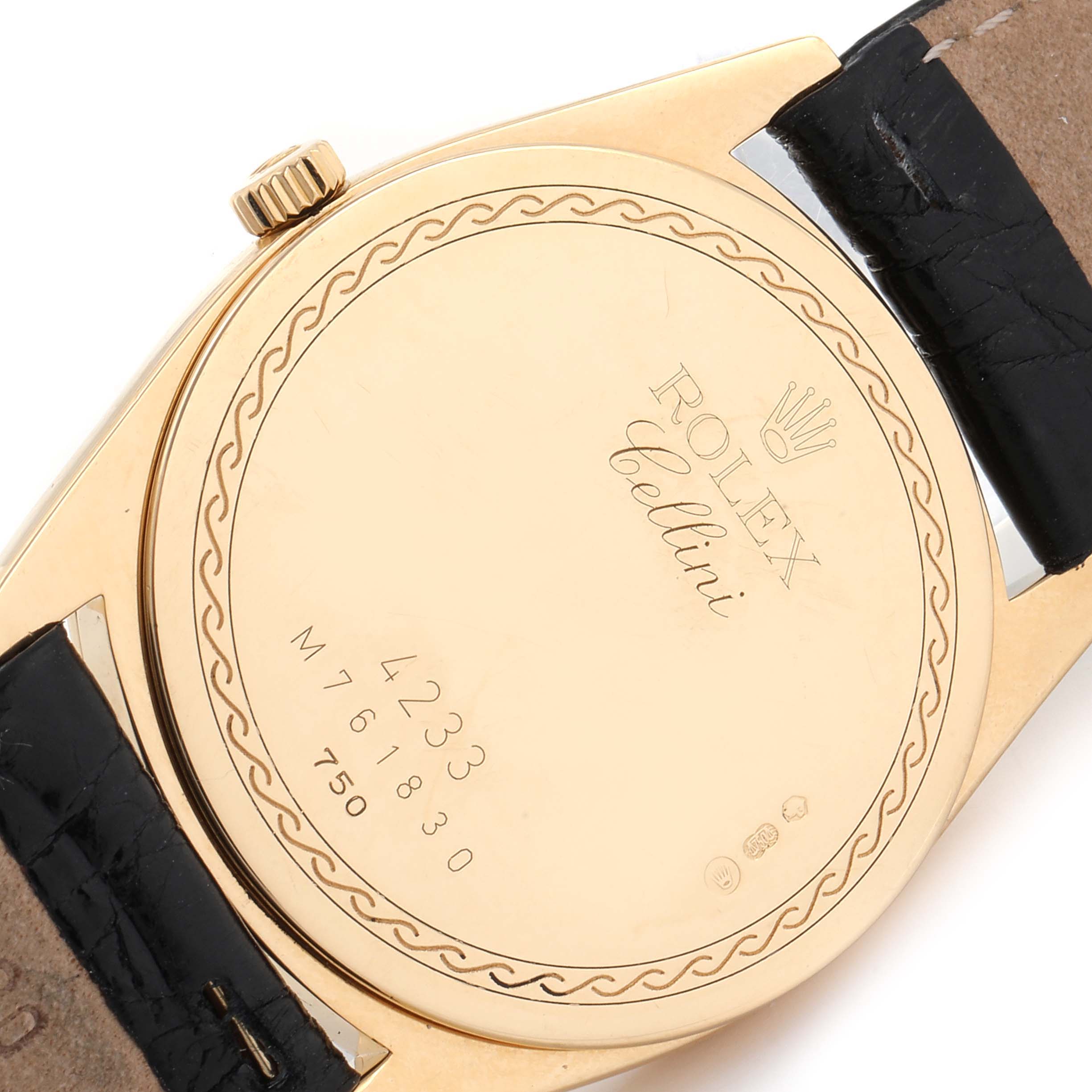 This image shows the back case of a Rolex Cellini 4233 Men's Yellow Gold Black Dial 4233 Men's Yellow Gold Black Dial watch, highlighting the engraved details and part of the leather strap.