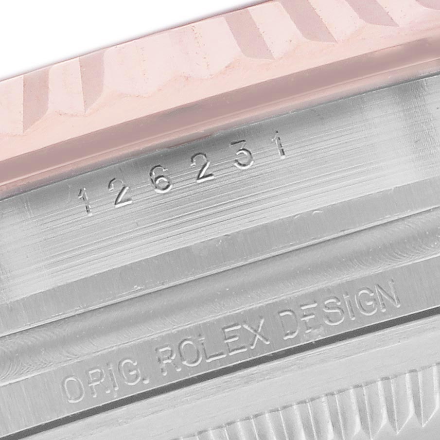 The image shows the side view of a Rolex Datejust 126231 Men's Steel and Gold (two tone) Pink Dial 126231 Men's Steel and Gold (two tone) Pink Dial, highlighting the engraved serial number and "ORIG. ROLEX DESIGN" text.
