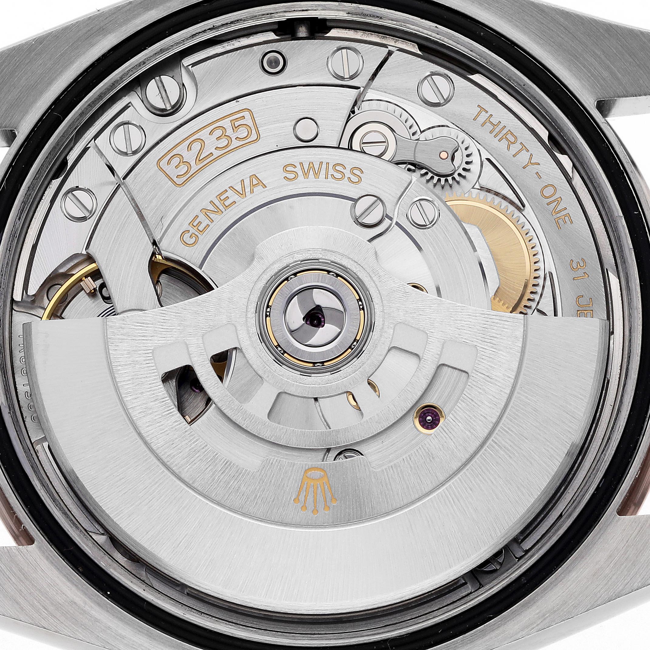 This image shows a close-up of the movement inside a Rolex Datejust 126231 Men's Steel and Gold (two tone) Pink Dial 126231 Men's Steel and Gold (two tone) Pink Dial, displaying gears and engraved details.