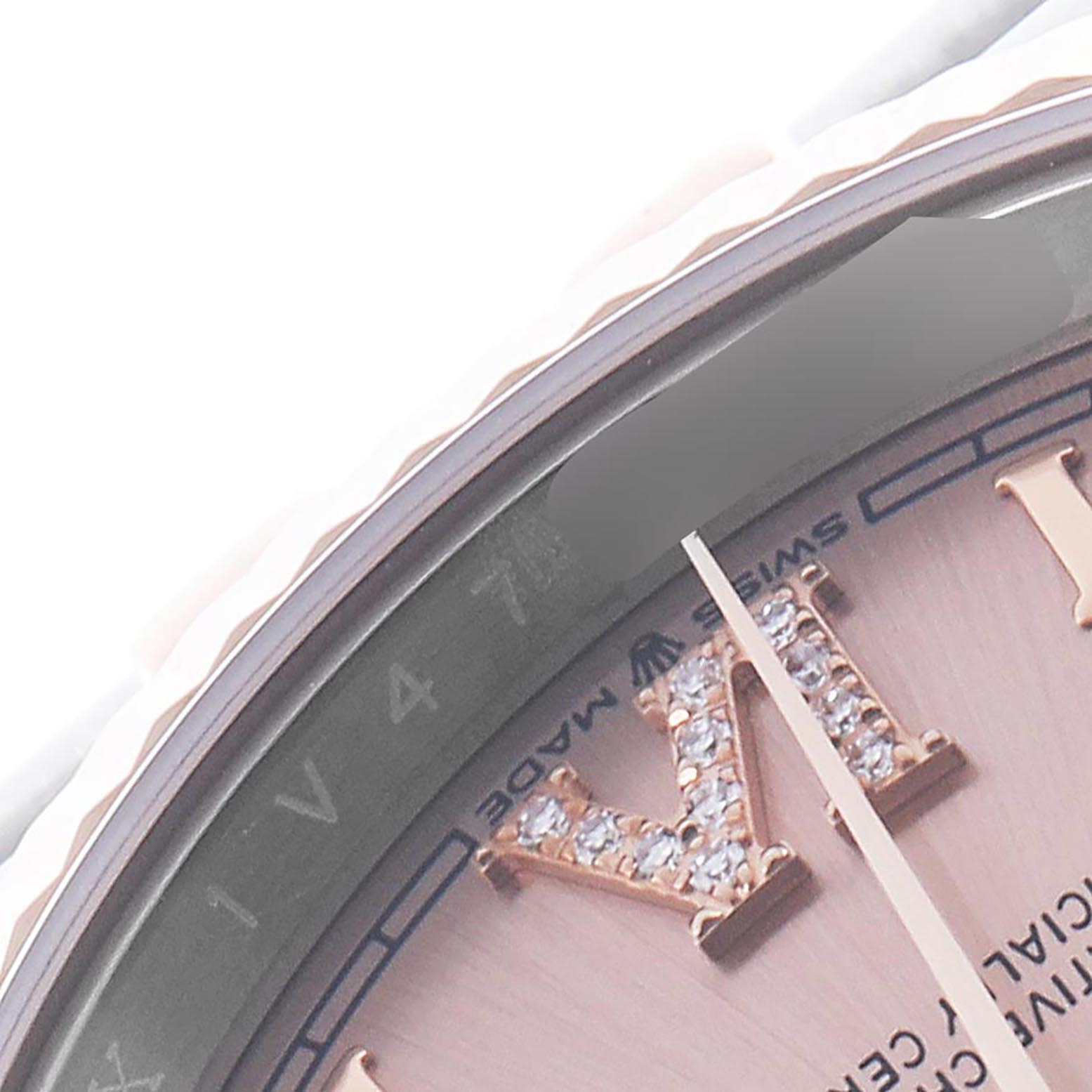 The image shows a close-up of the Rolex Datejust 126231 Men's Steel and Gold (two tone) Pink Dial 126231 Men's Steel and Gold (two tone) Pink Dial, highlighting its bezel, Roman numeral, and part of the dial.