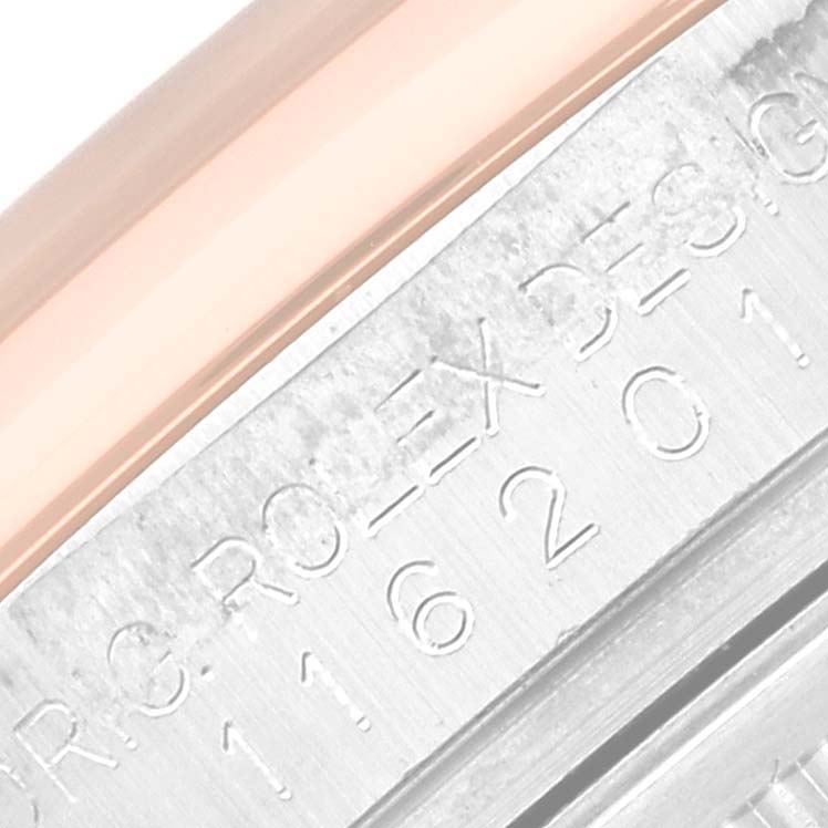 This close-up image shows part of the engraved side of a Datejust model by Rolex, including some serial numbers.