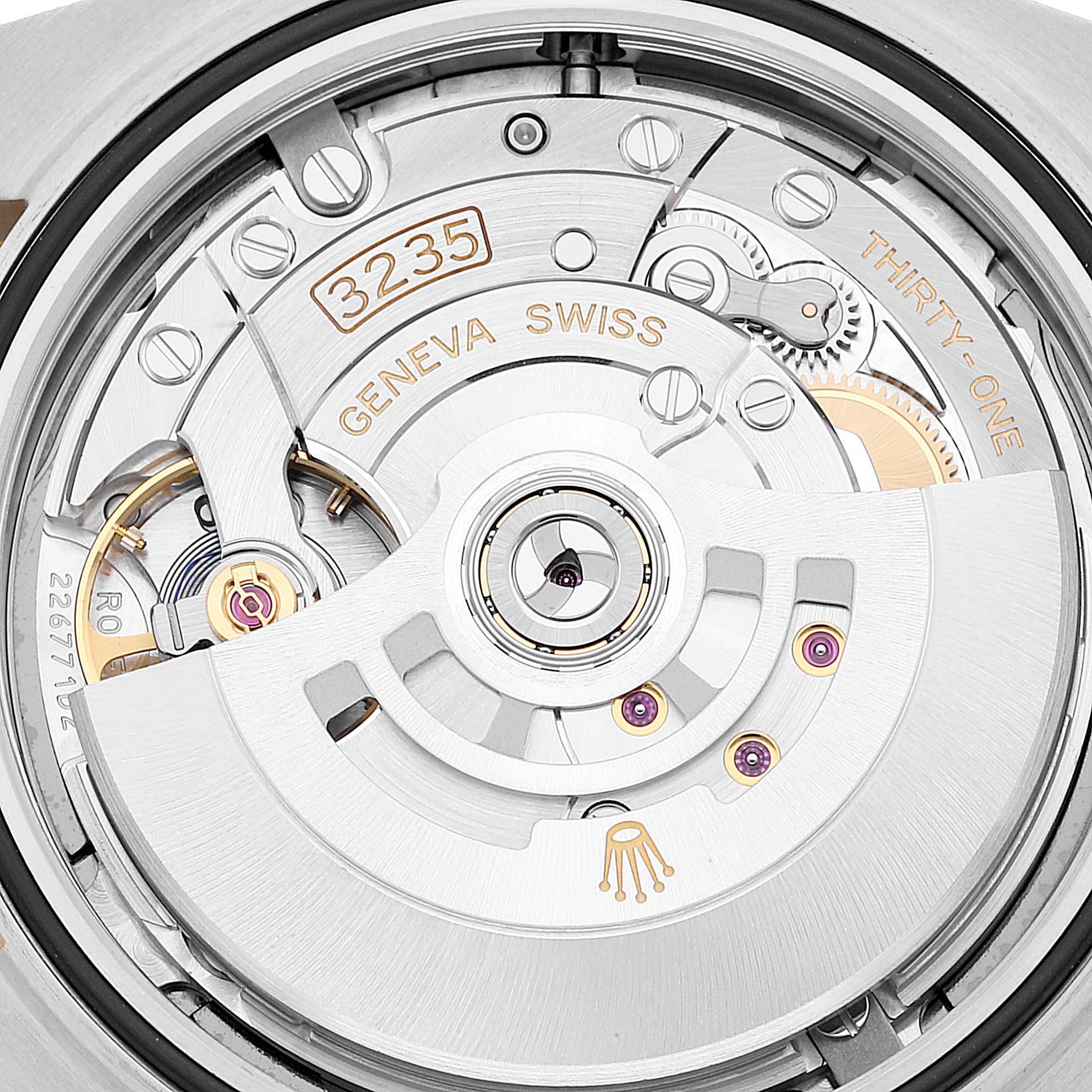 This is a close-up of the Rolex Datejust 41 126303 Men's Steel and Gold (two tone) Grey Dial 126303 Men's Steel and Gold (two tone) Grey Dial movement, showcasing the intricate Geneva Swiss mechanism and components.