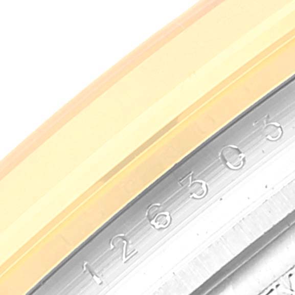 This image shows a close-up of the engraved serial number on the rehaut of a Rolex Datejust 41 126303 Men's Steel and Gold (two tone) Grey Dial 126303 Men's Steel and Gold (two tone) Grey Dial watch.